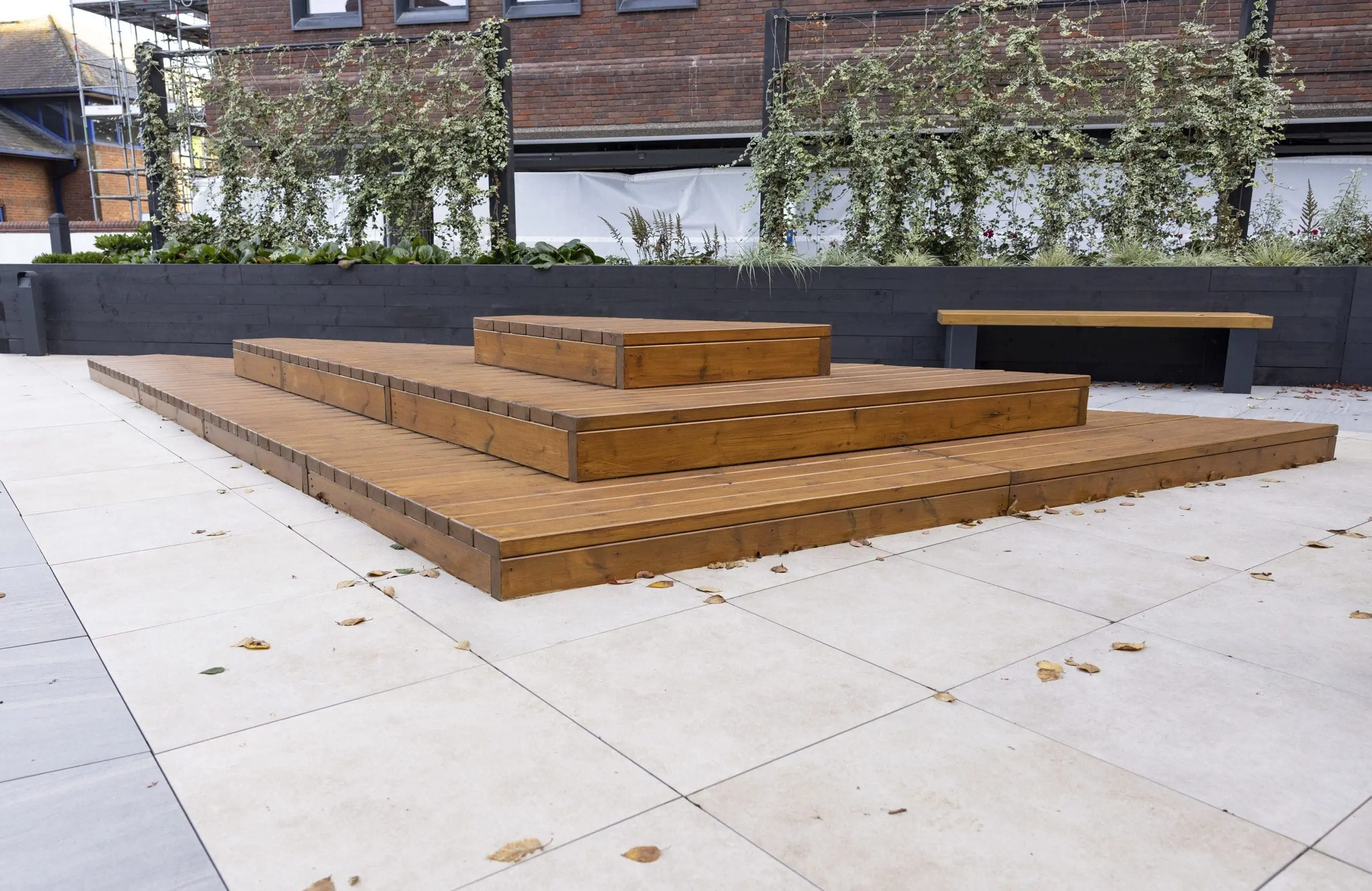 wooden stepped three tier decking doubling as exterior seating area