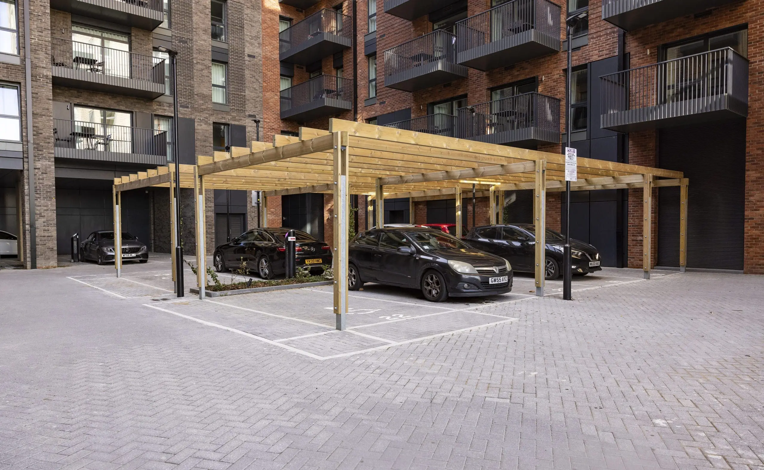 collection-of-wooden-pergolas-covering-car-parking-spaces-outside