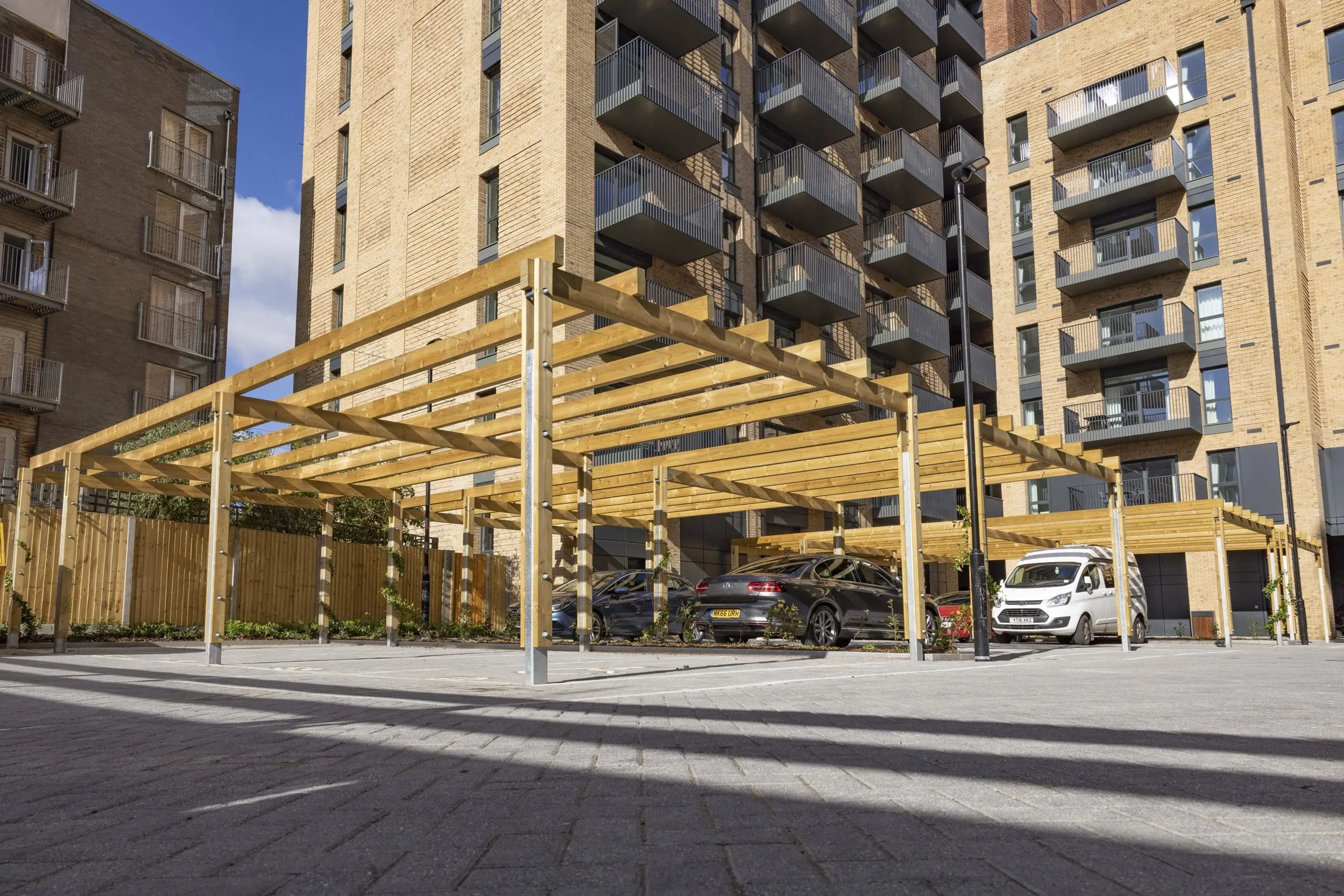 collection-of-wooden-pergolas-covering-car-parking-spaces-outside