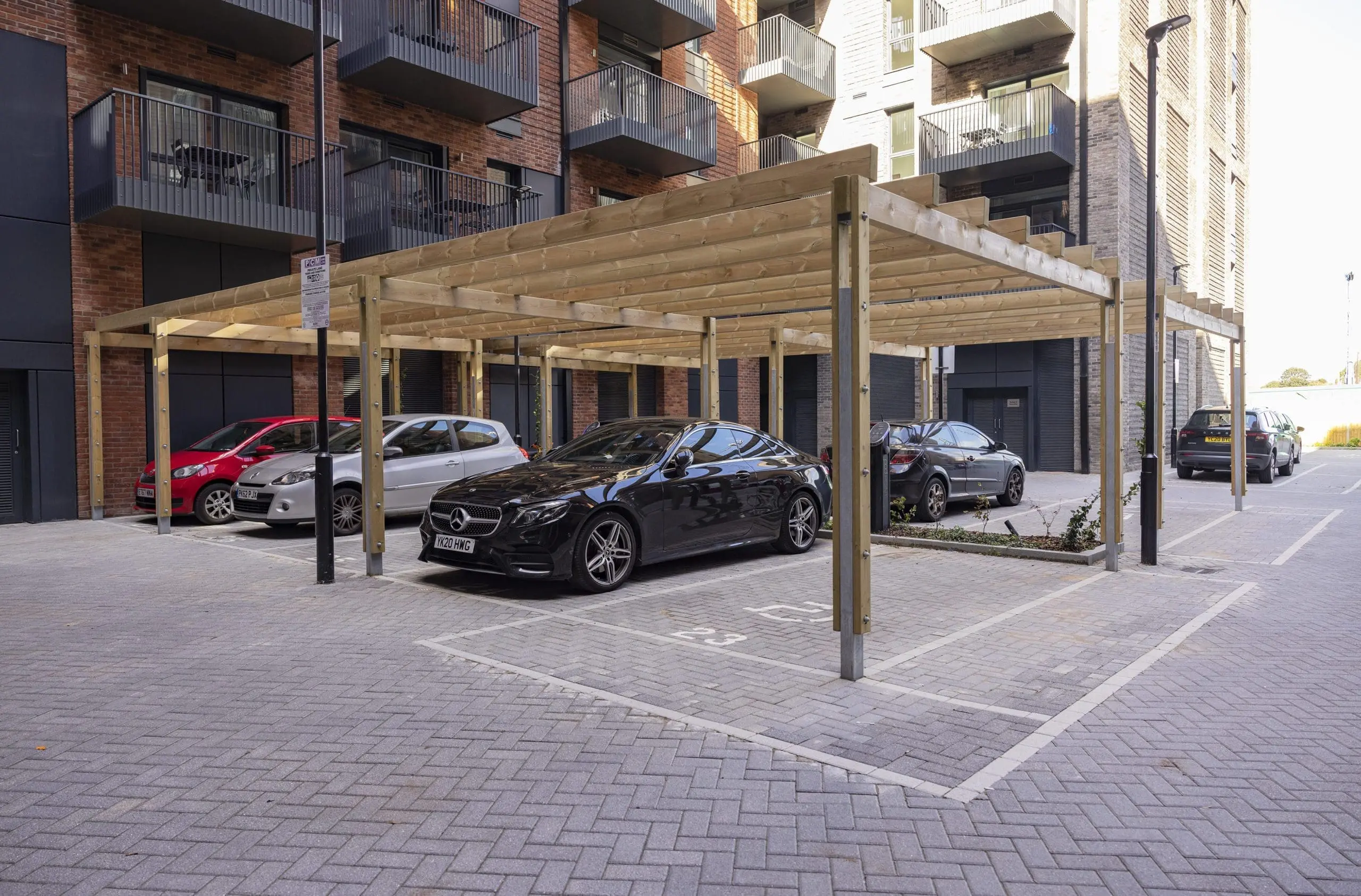 collection-of-wooden-pergolas-covering-car-parking-spaces-outside