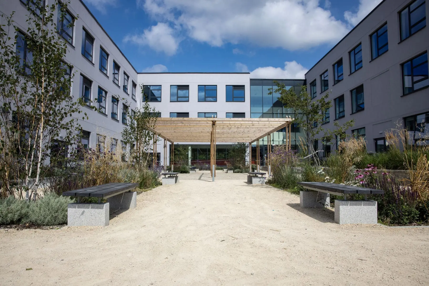 wooden pergola in the middle of the school courtyard