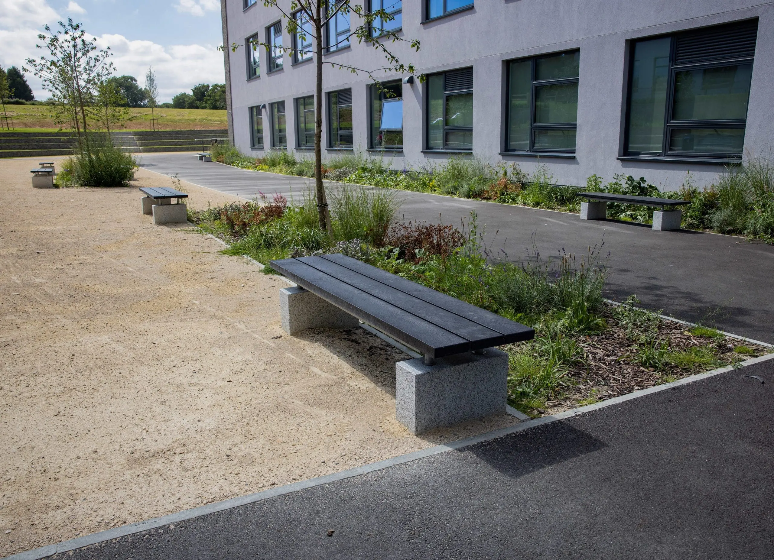 black wooden benches with concrete feet