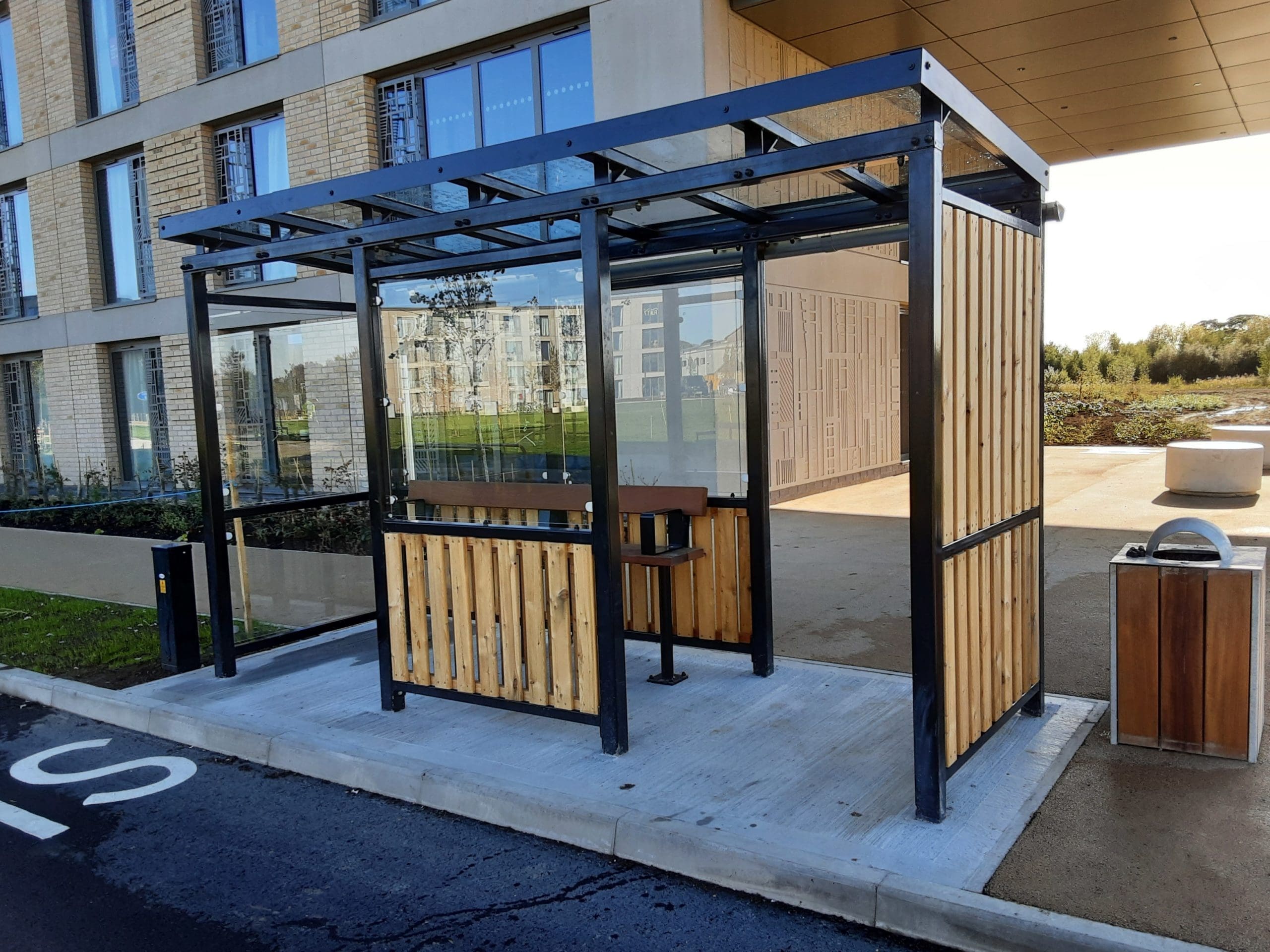 black-metal-and-light-wooden-bus-stop