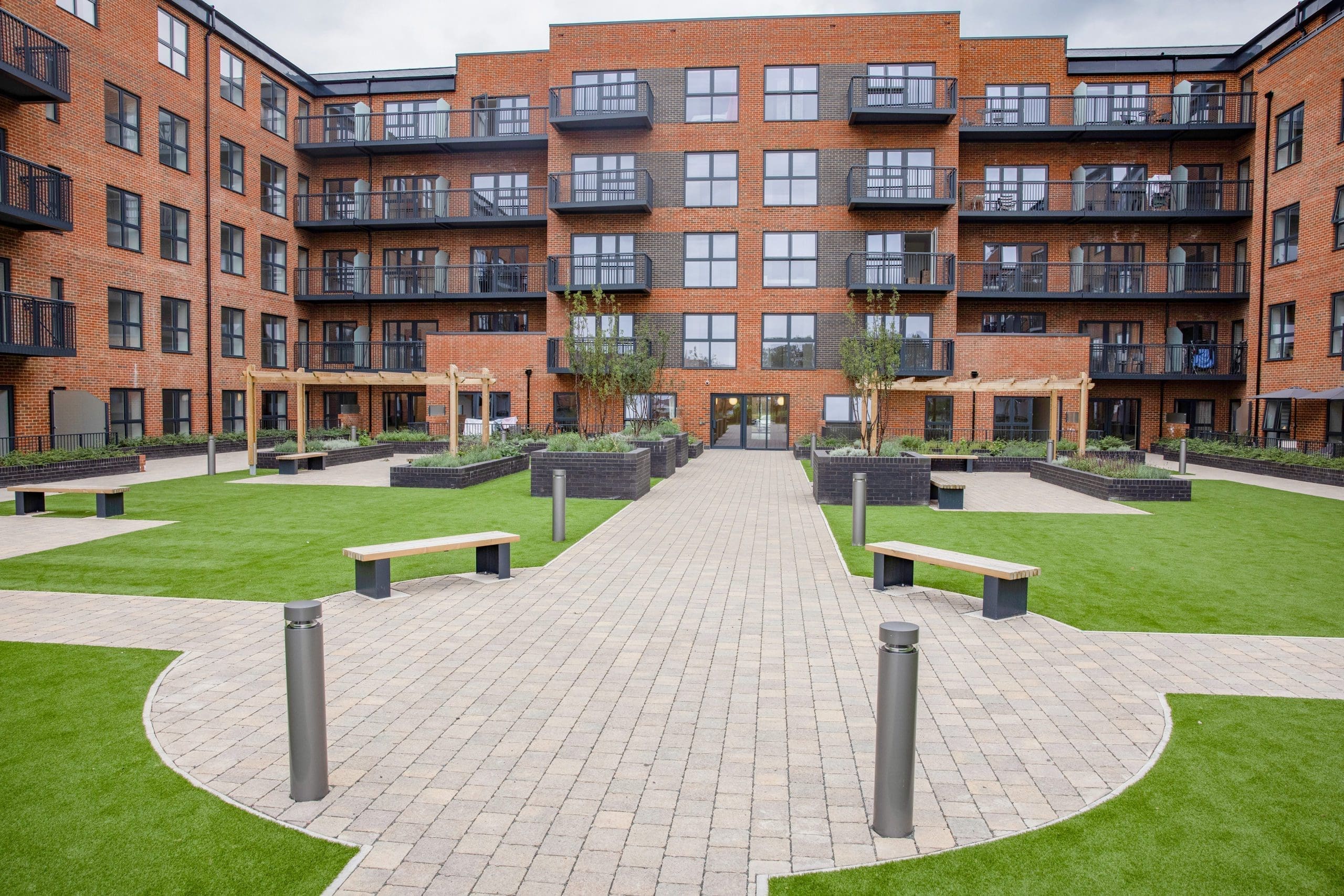 wide-shot-of-housing-courtyard-symetrical-seating-and-pergolas