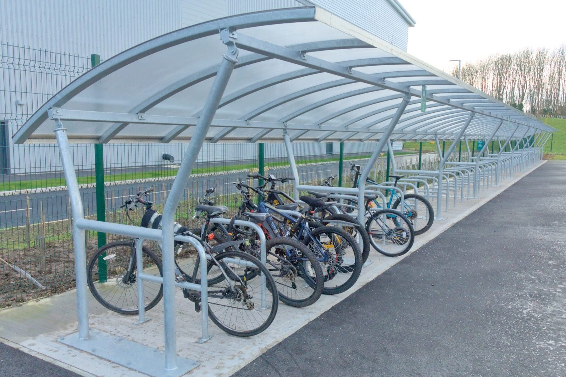 close up of bike shelter outside warehouse with bikes attached
