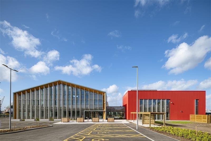 wide shot of the front of offices red building and glass building