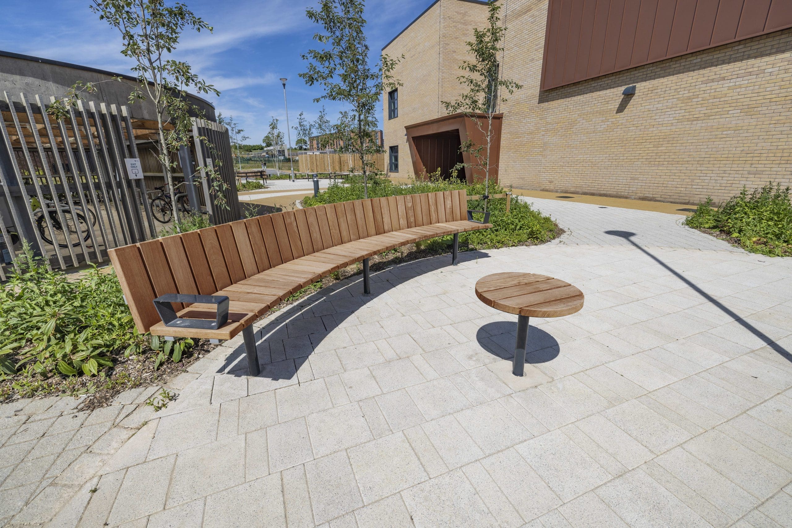 outdoor-wooden-curved-bench-metal-feet-and-small-round-matching-table
