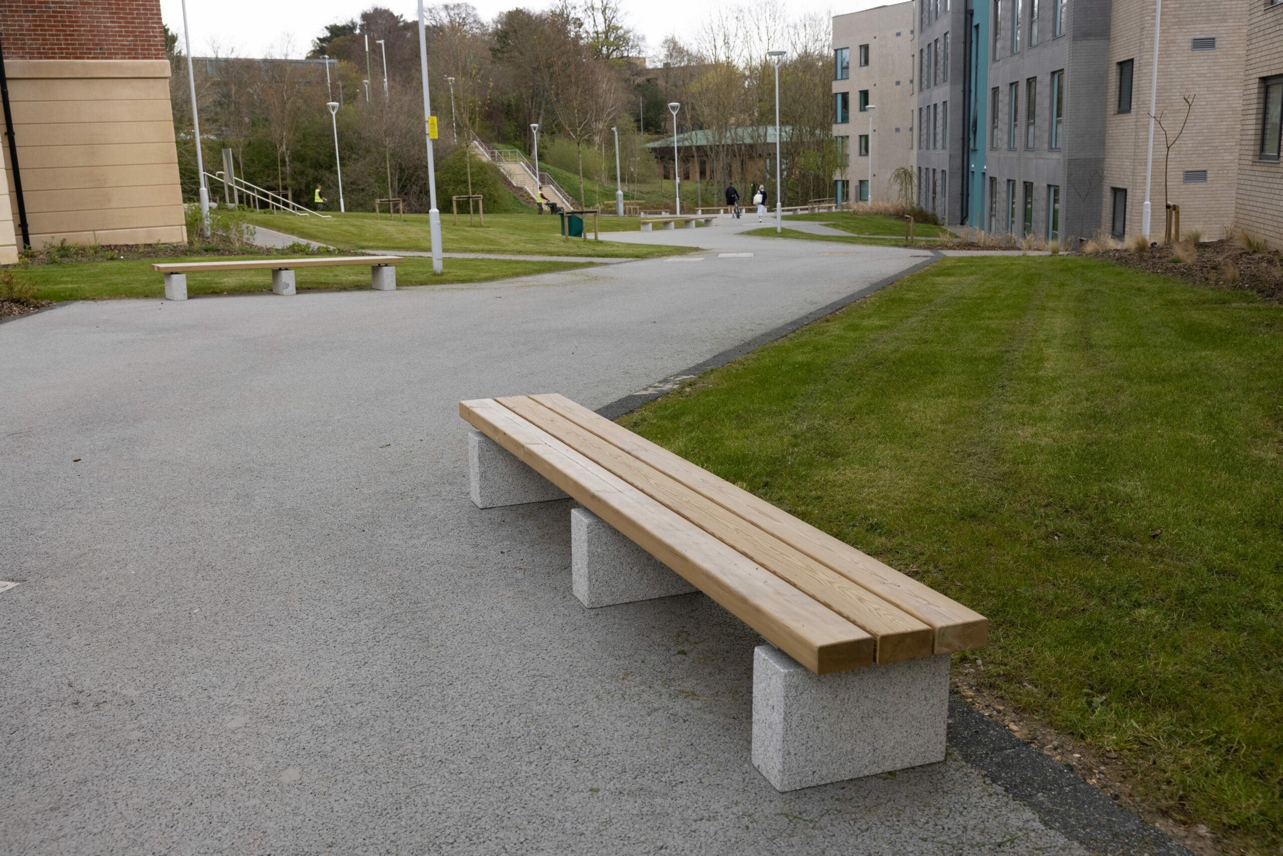 outdoor wooden bench with concrete plinth legs