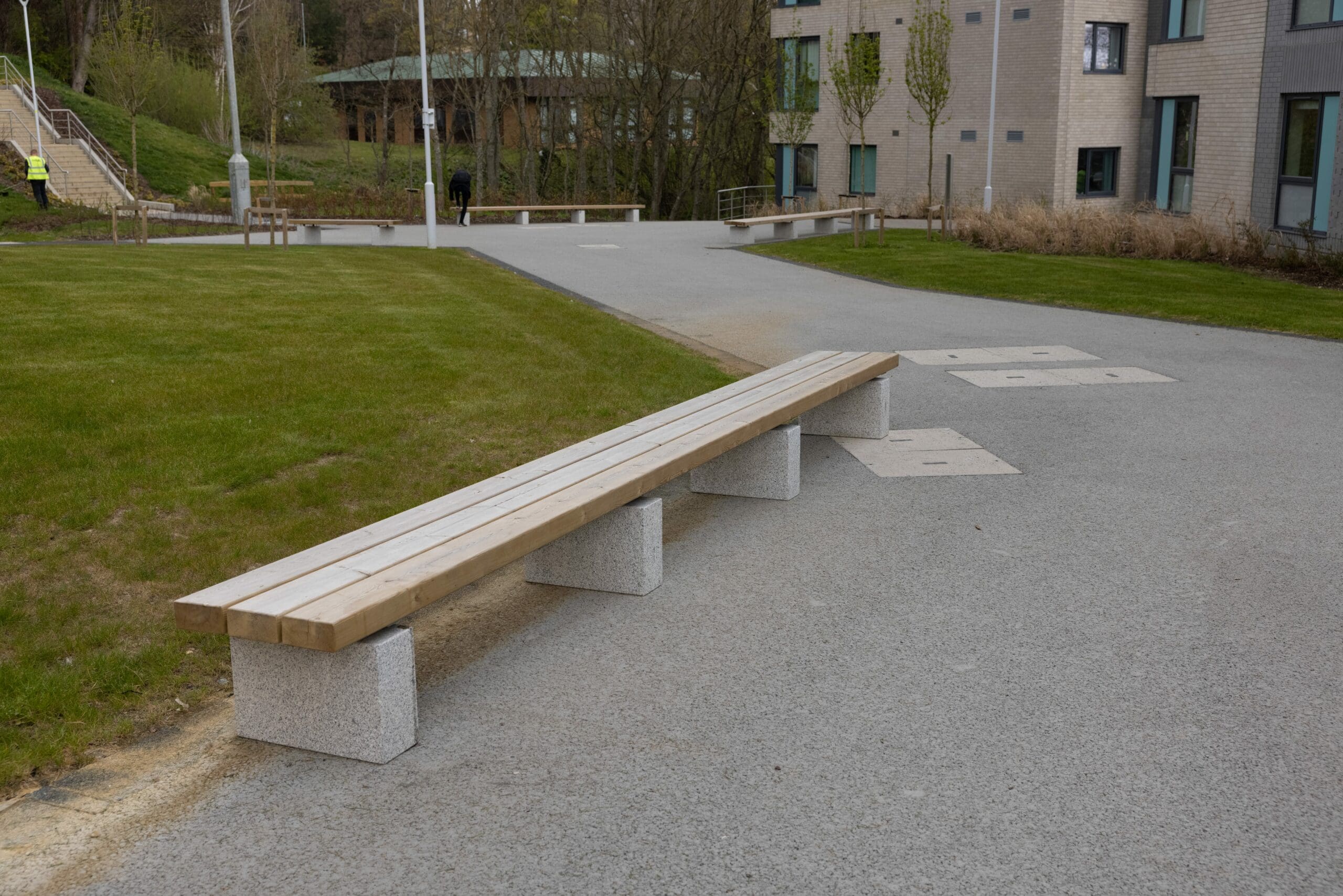 outdoor wooden bench with concrete plinth legs