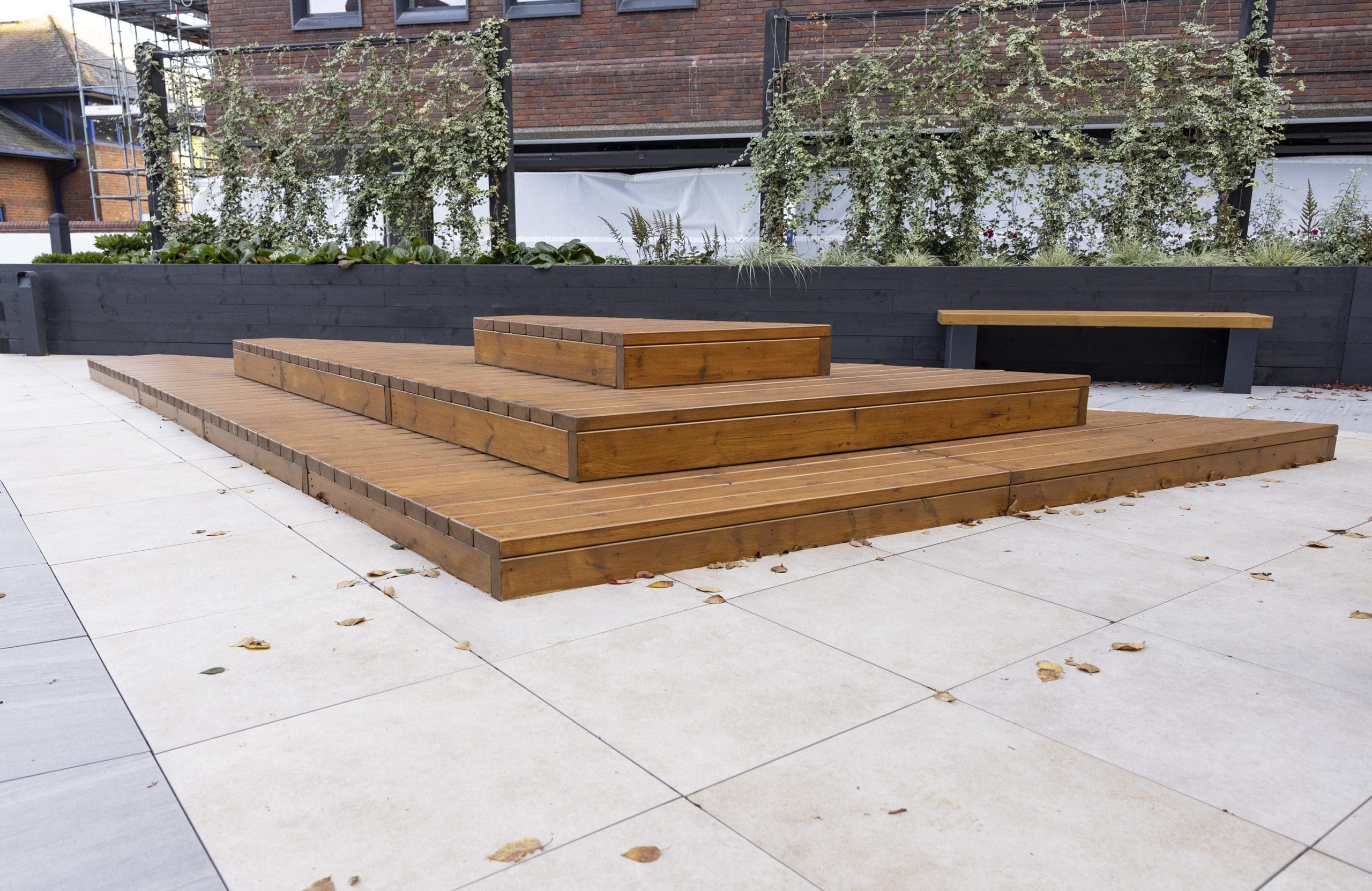 wooden stepped three tier decking doubling as exterior seating area
