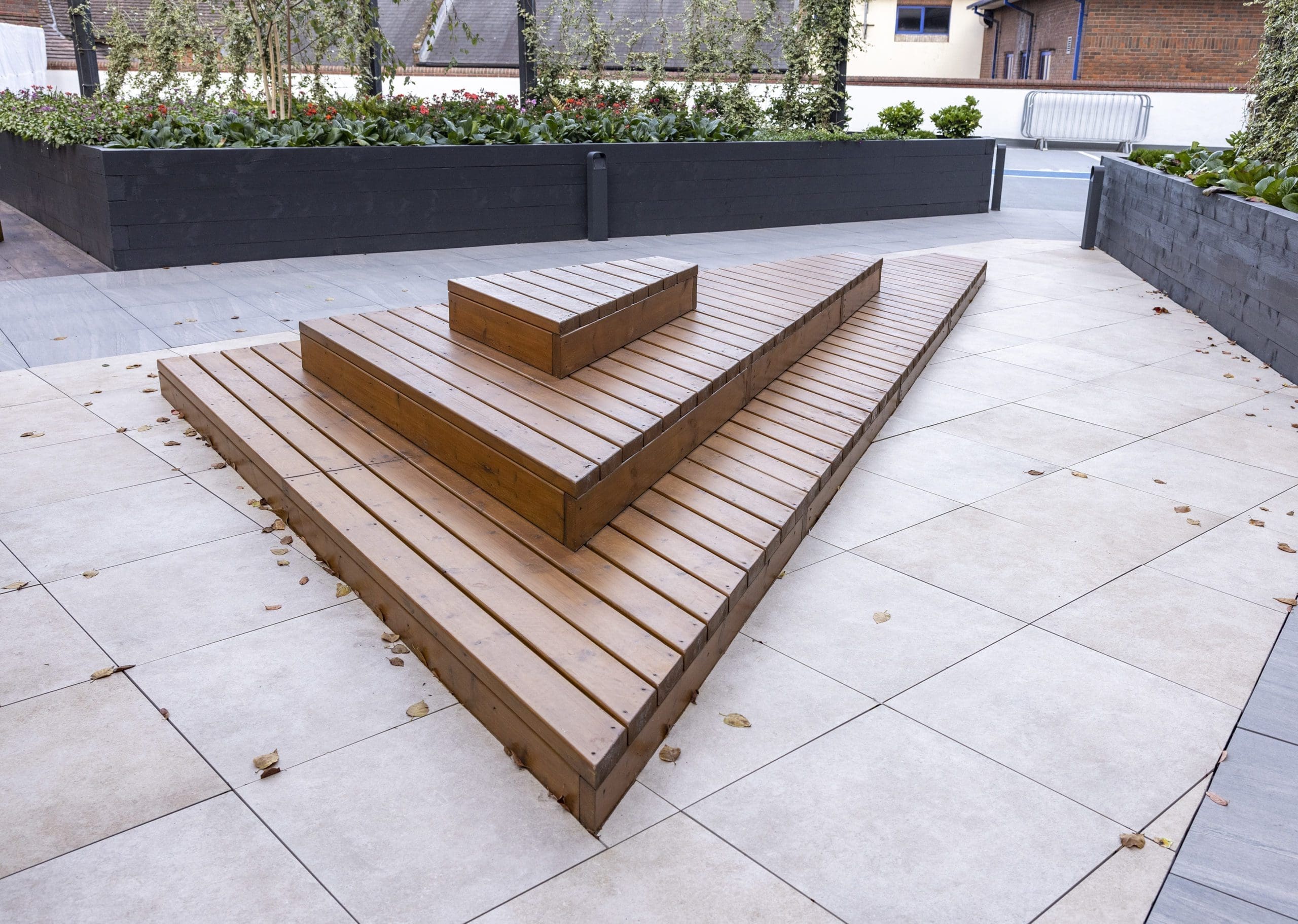 wooden stepped three tier decking doubling as exterior seating area