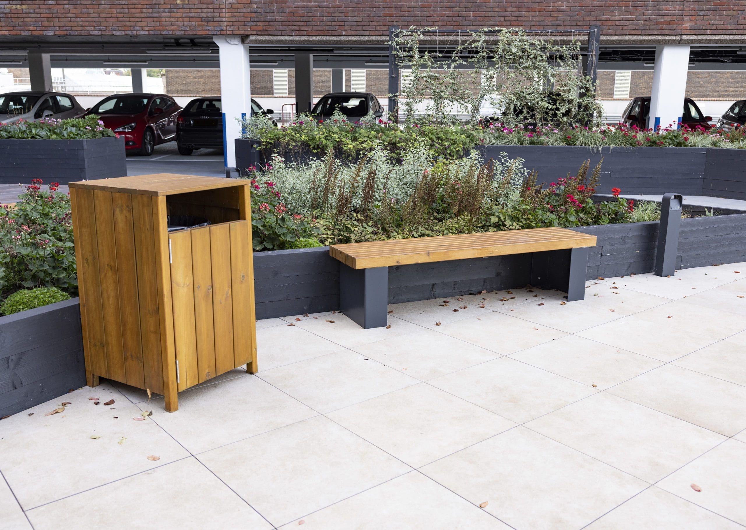 wooden outdoor bin and bench with black metal legs