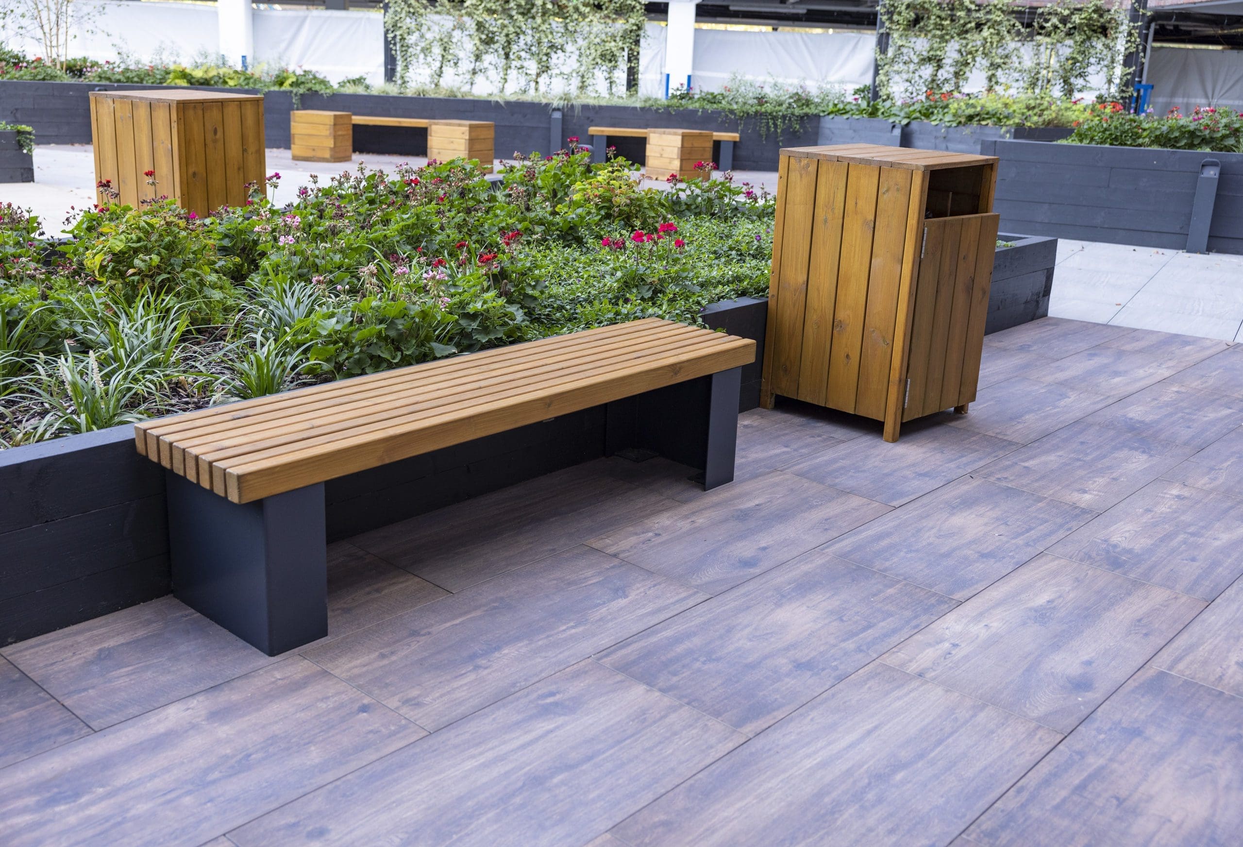 wooden outdoor bin and bench with black metal legs