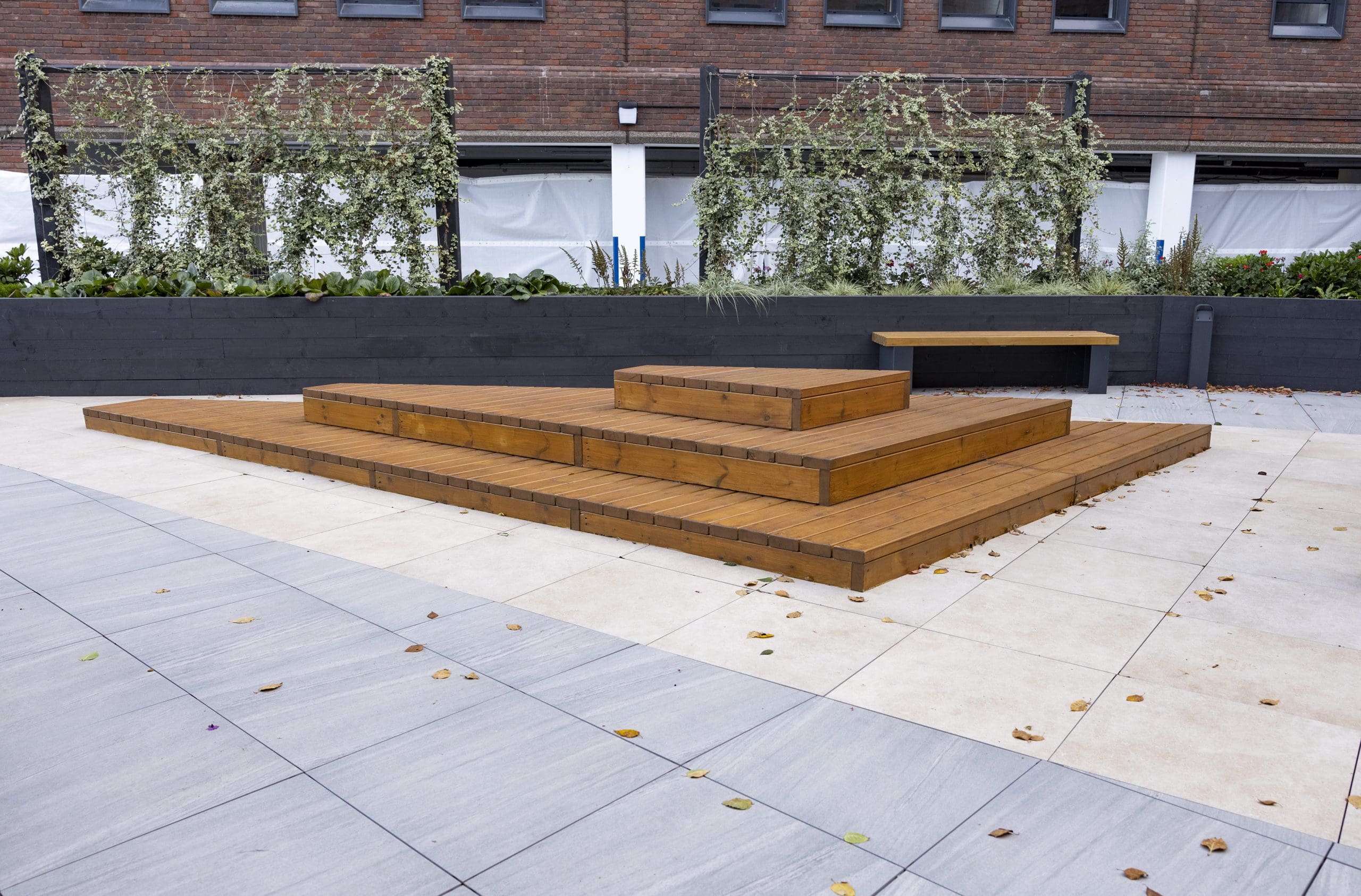 wooden stepped three tier decking doubling as exterior seating area