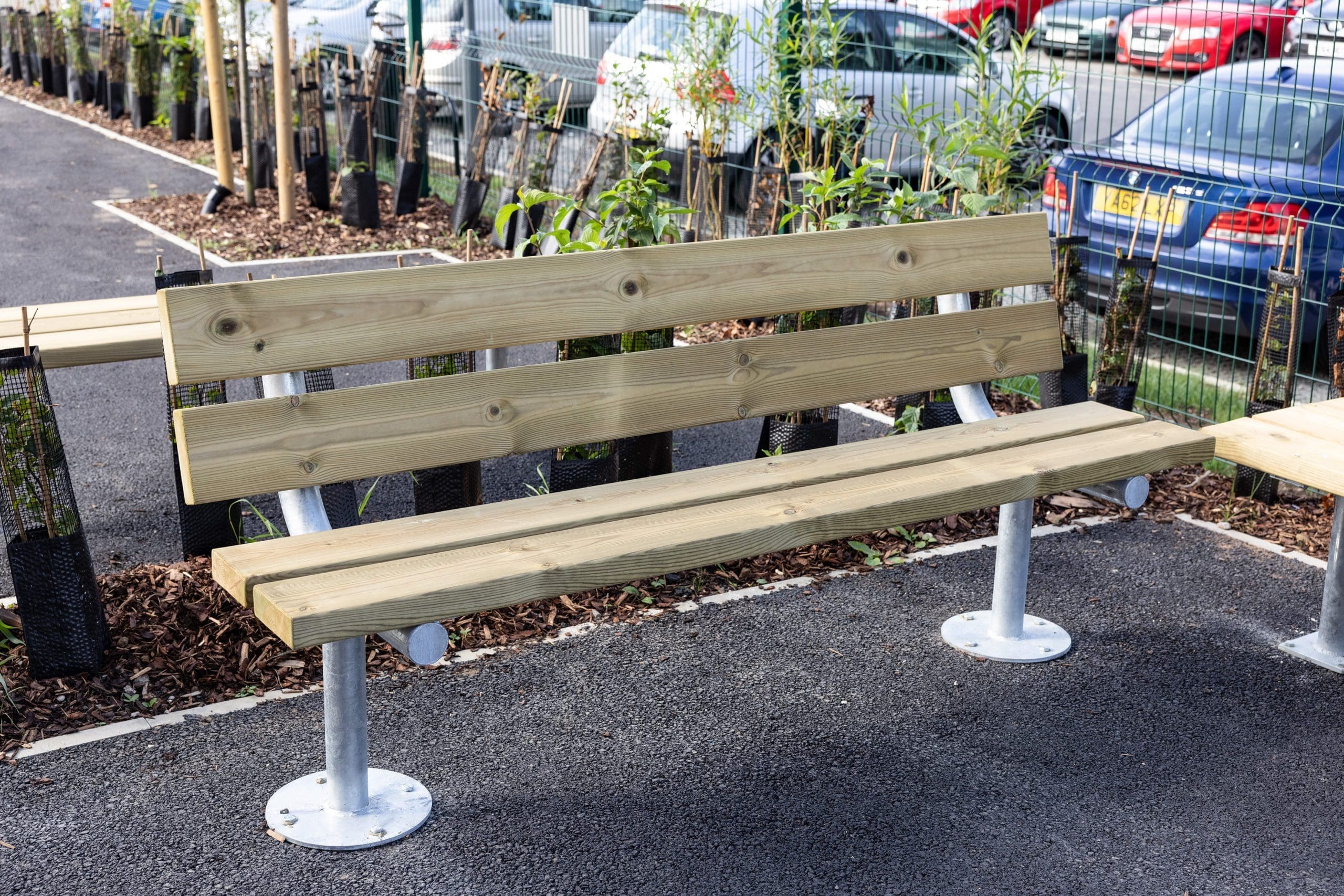 Outdoor rectangular wooden bench with metal legs and curved wooden back