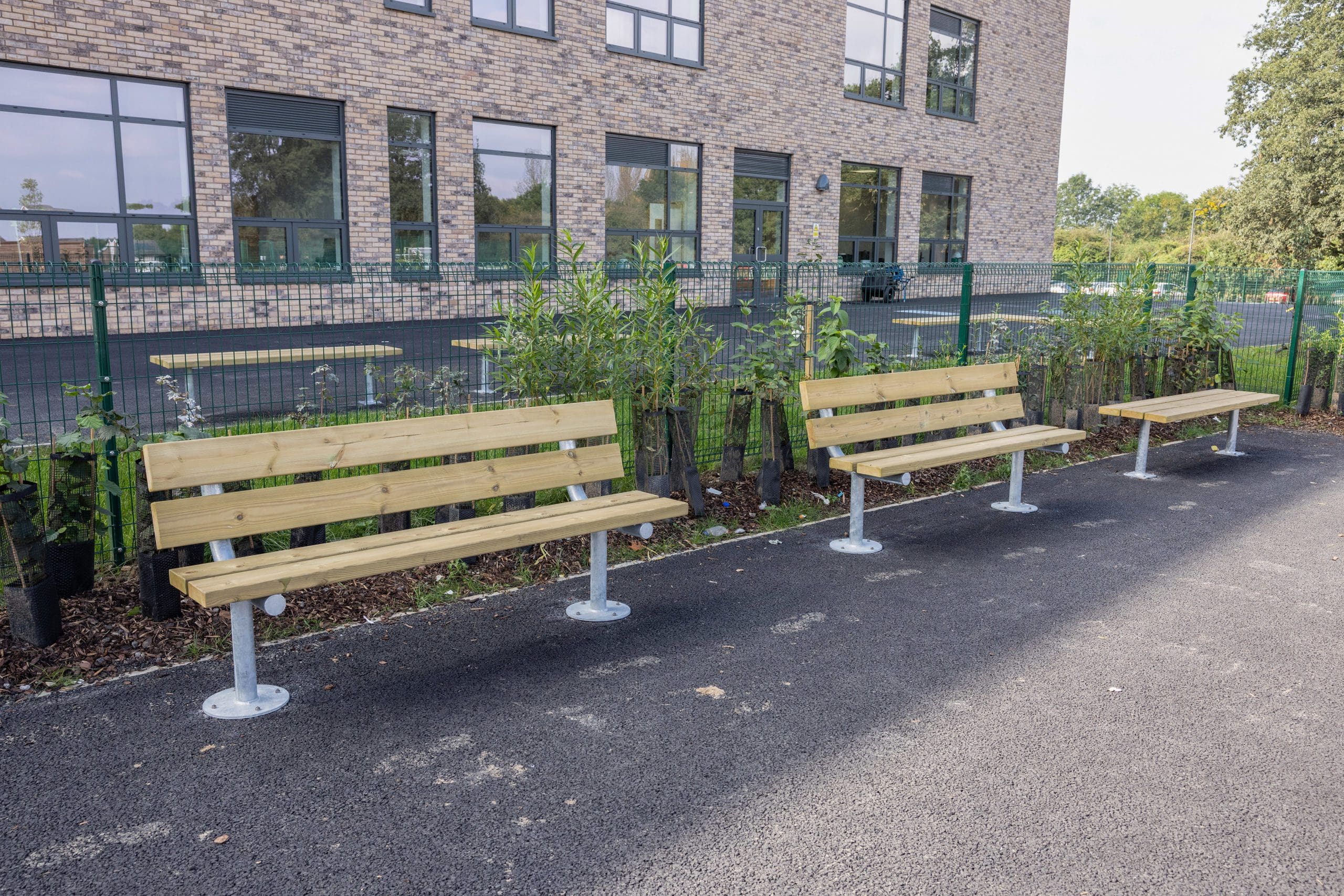 Outdoor rectangular wooden benches with metal legs and curved wooden backs