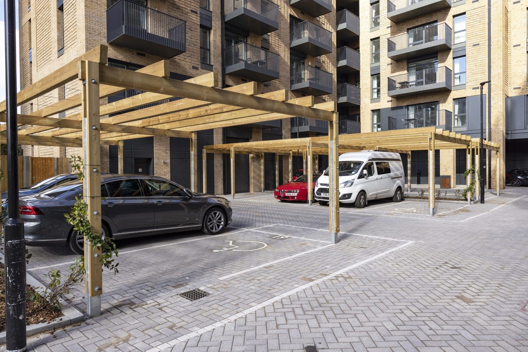 collection-of-wooden-pergolas-covering-car-parking-spaces-outside