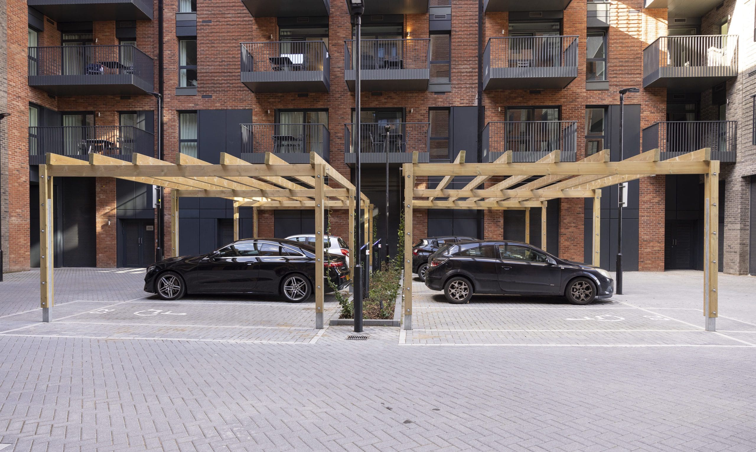 collection-of-wooden-pergolas-covering-car-parking-spaces-outside