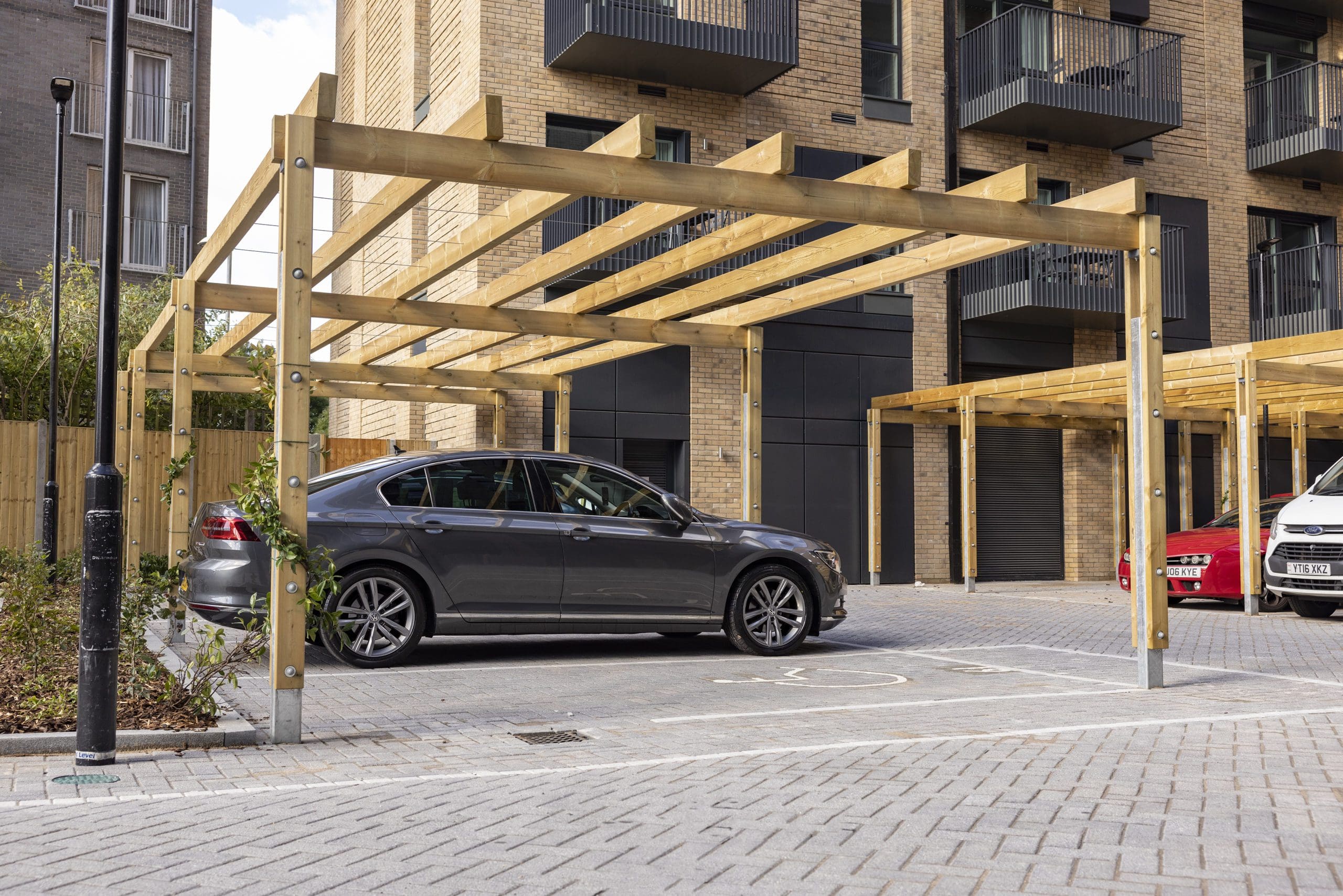 collection-of-wooden-pergolas-covering-car-parking-spaces-outside
