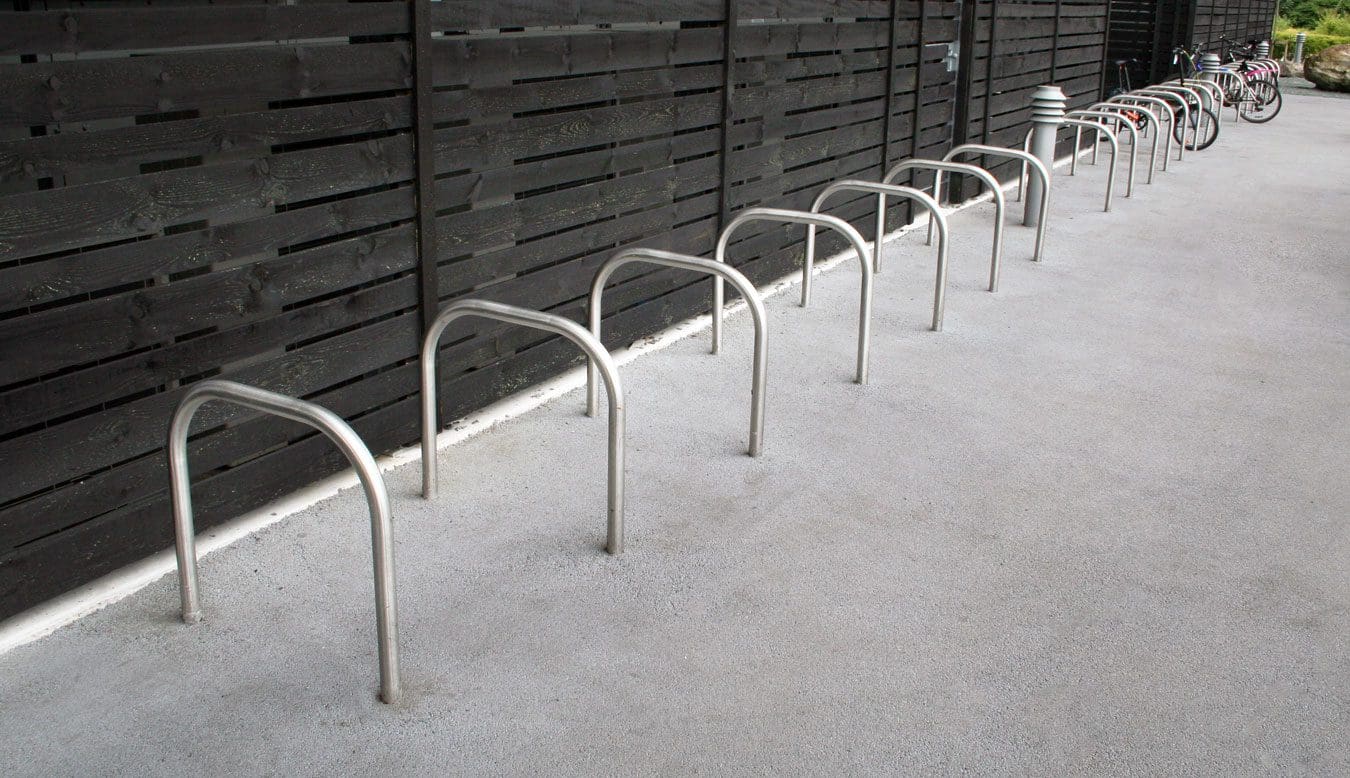 Metal hoop bicycle rack in concrete floor