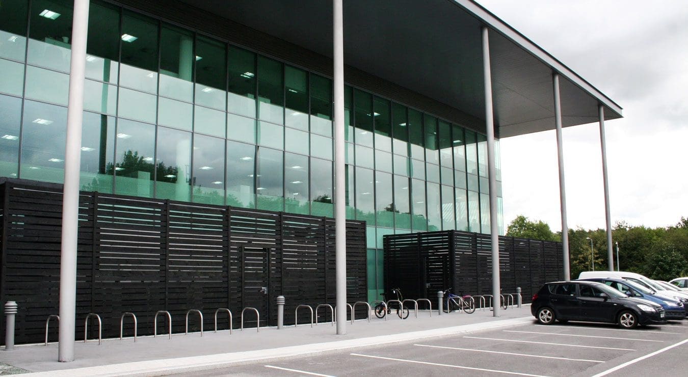 Wide shot of office building with row of metal hoop bicycle racks