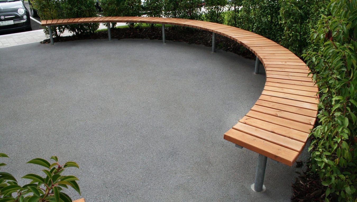 Closeup of wooden semi circle bench seating with metal legs