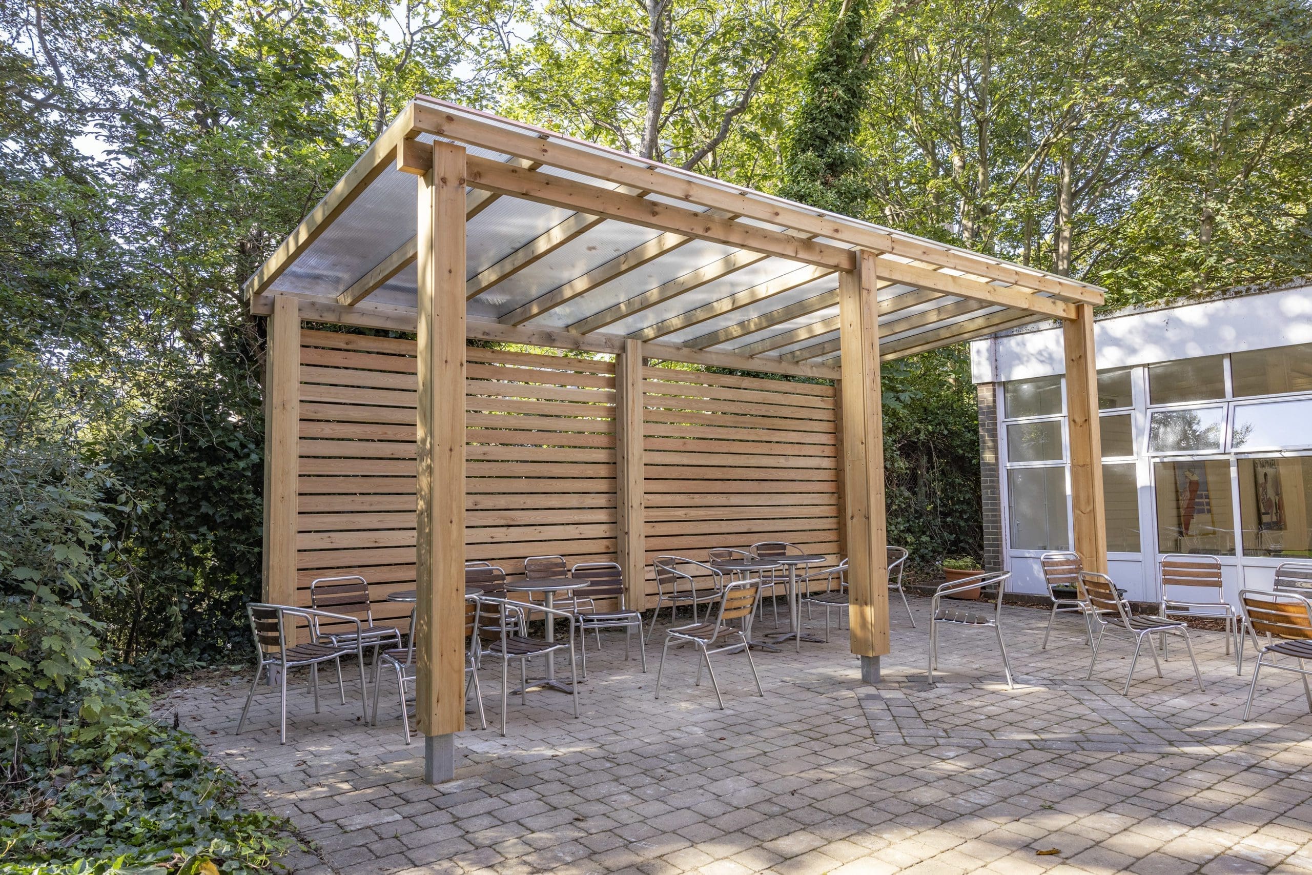 outdoor wooden pergola shelter covering seating area