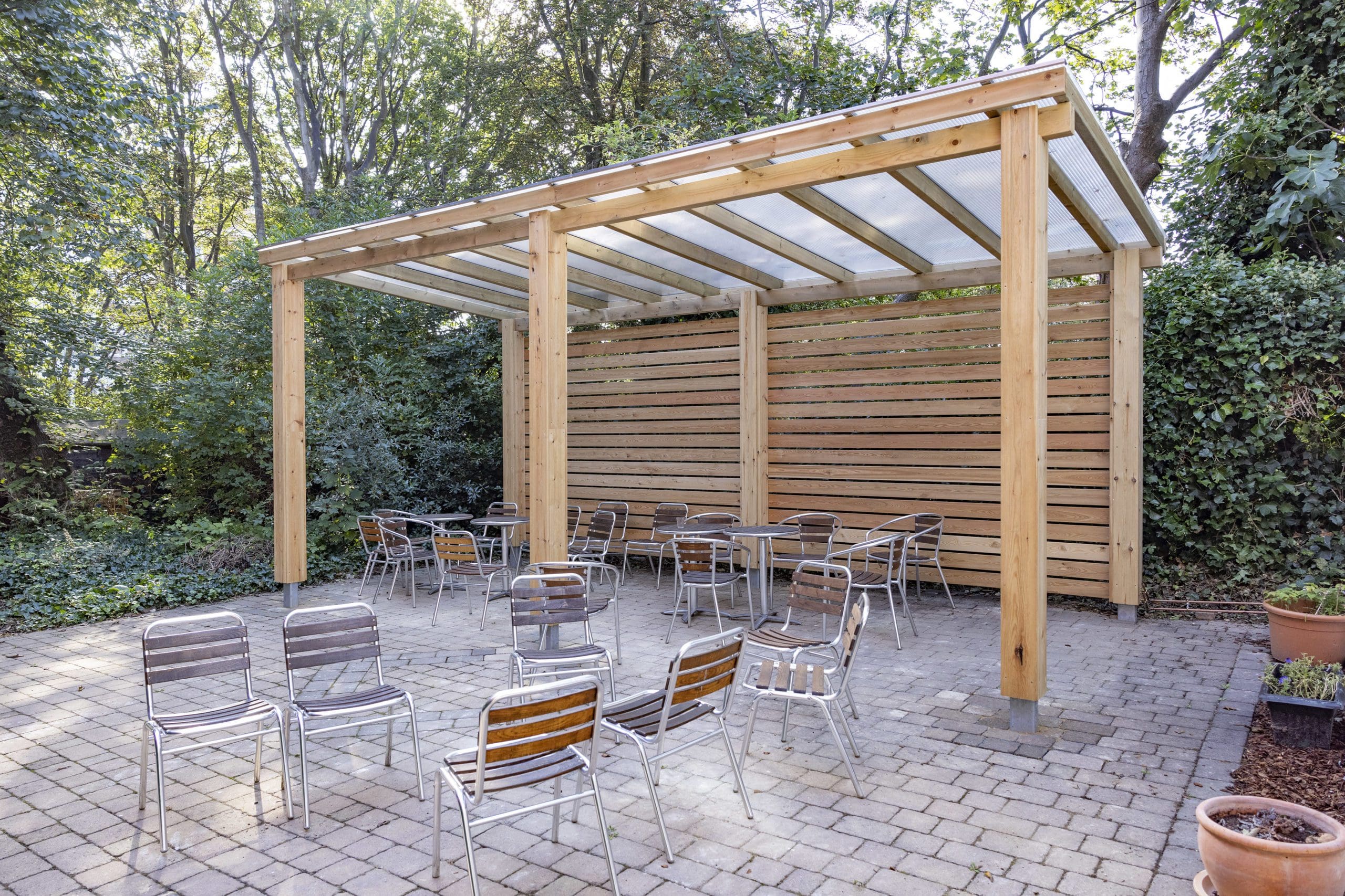 outdoor wooden pergola shelter covering seating area