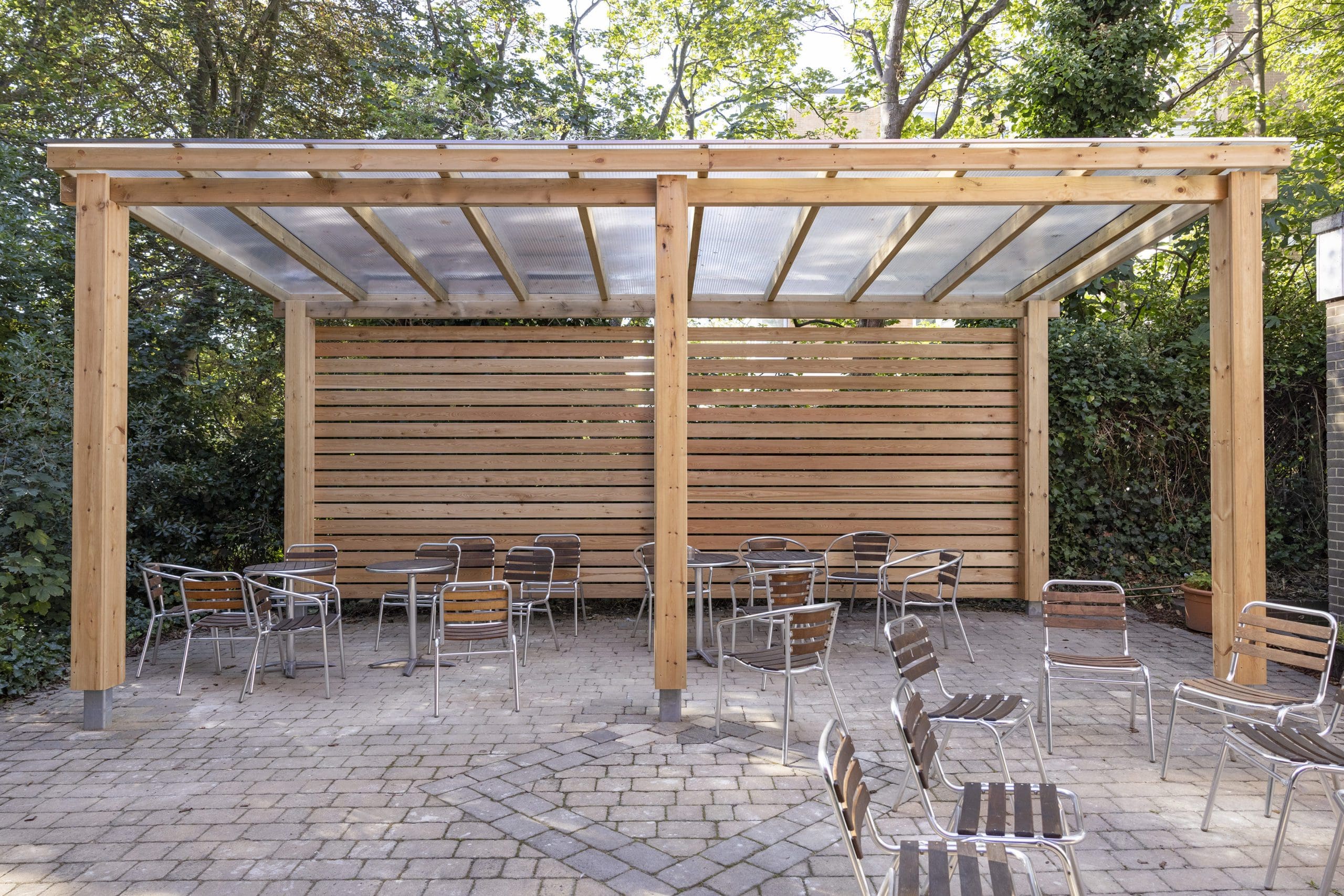 outdoor wooden pergola shelter covering seating area