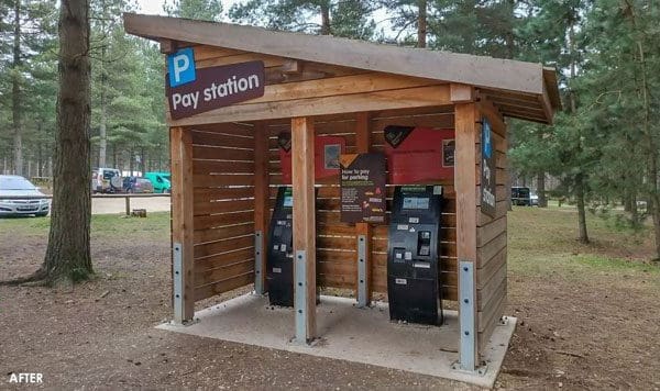 Small angled wooden outdoor canopy turned into pay station for parking