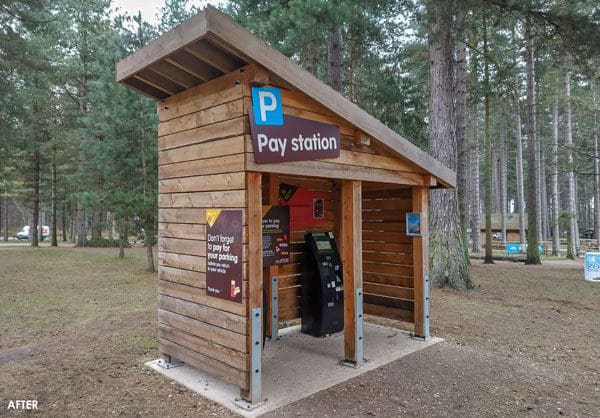 Small angled wooden outdoor canopy turned into pay station for parking