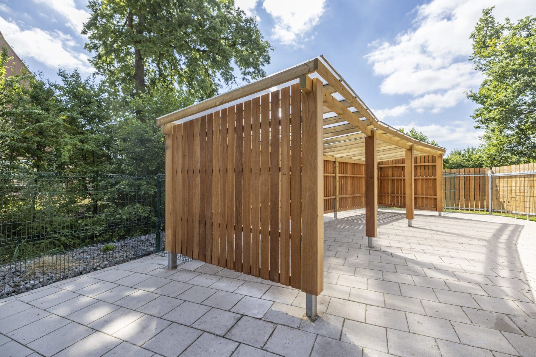 Outdoor large wooden canopy with closed sides, open front and seethrough roof