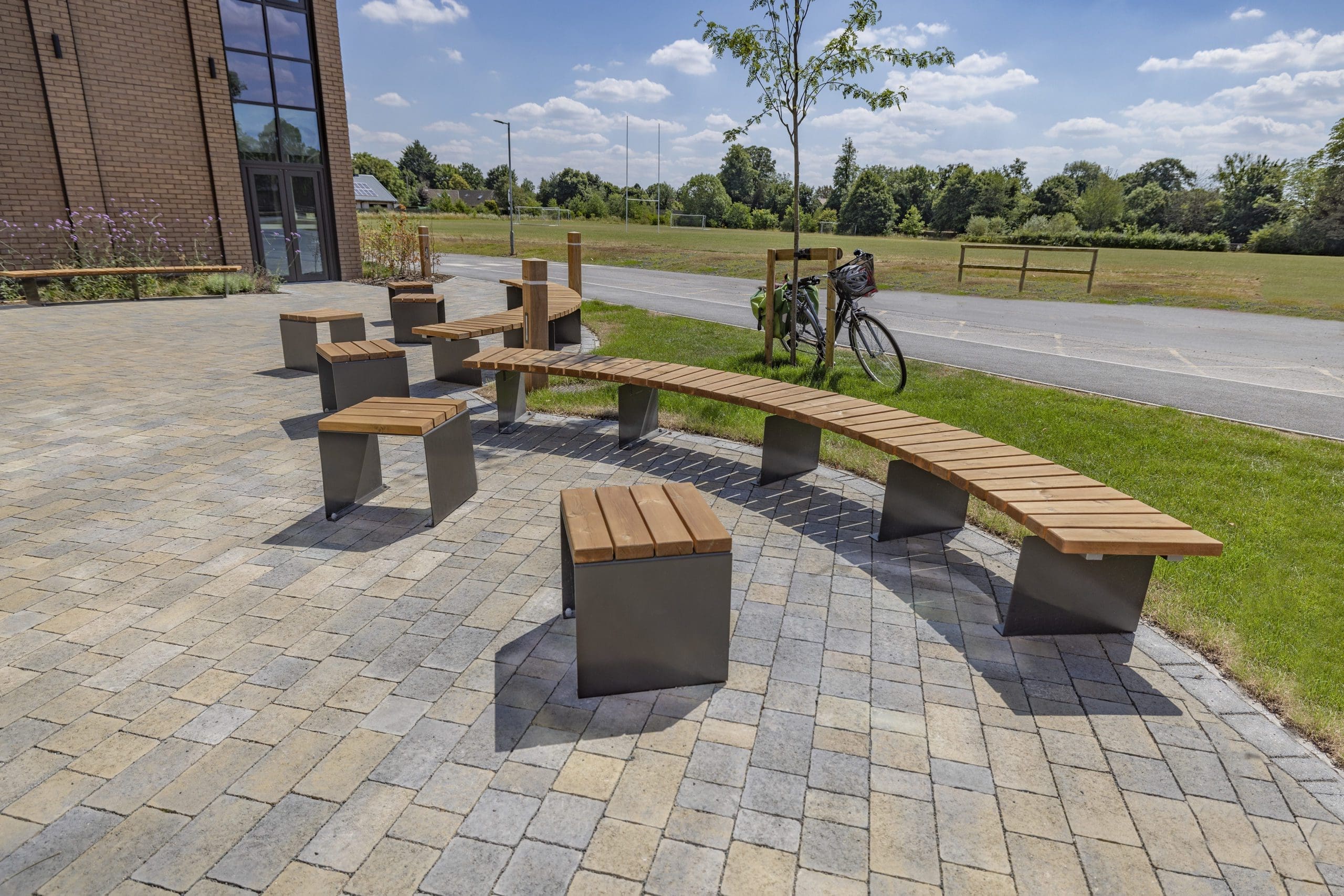 exterior-wooden-curved-benches-black-metal-legs-and-matching-single-seats