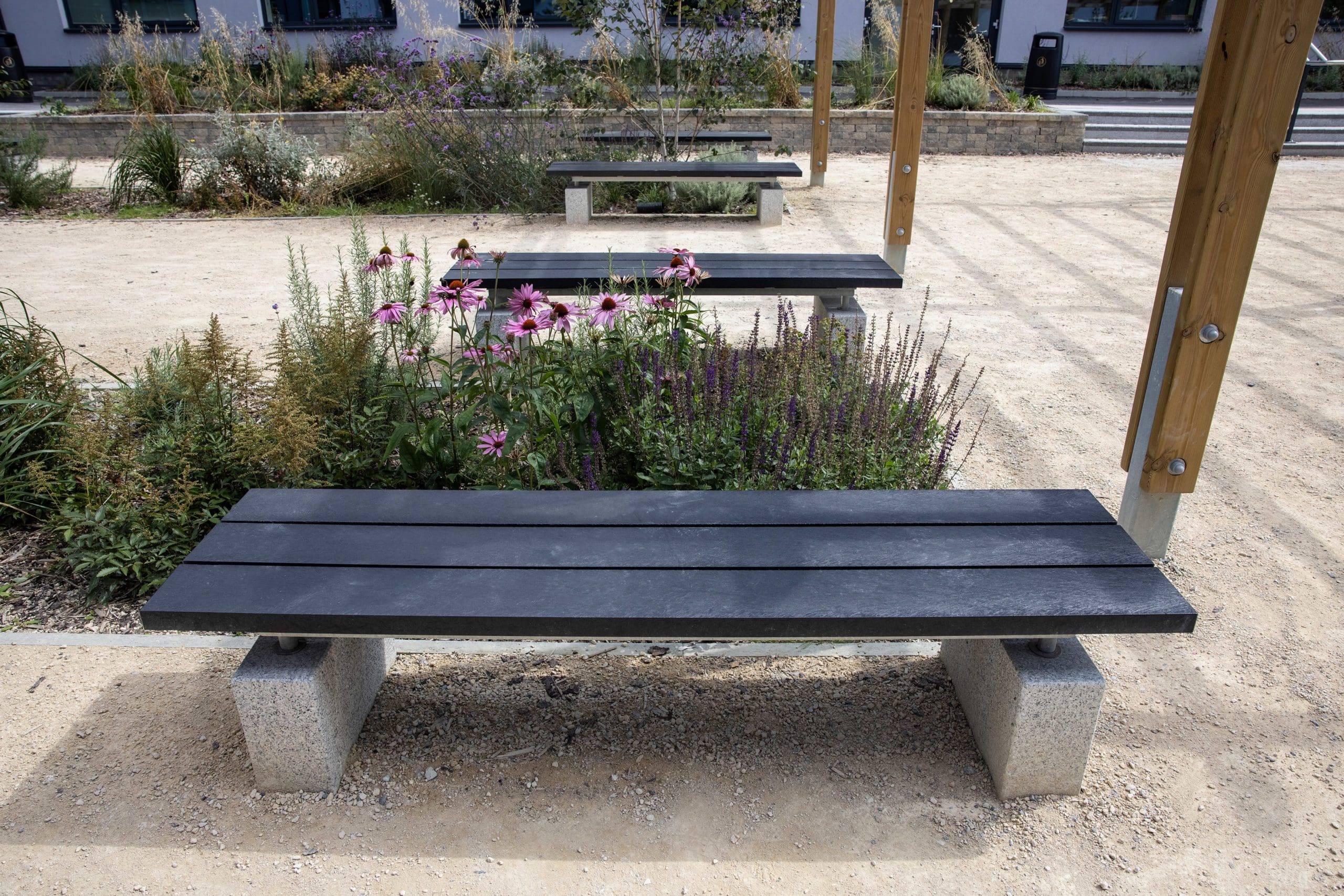 black wooden benches with concrete feet