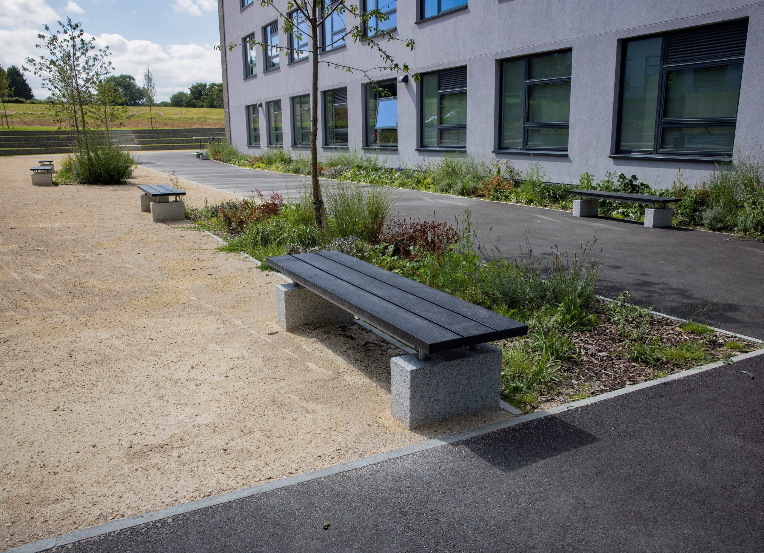 black wooden benches with concrete feet