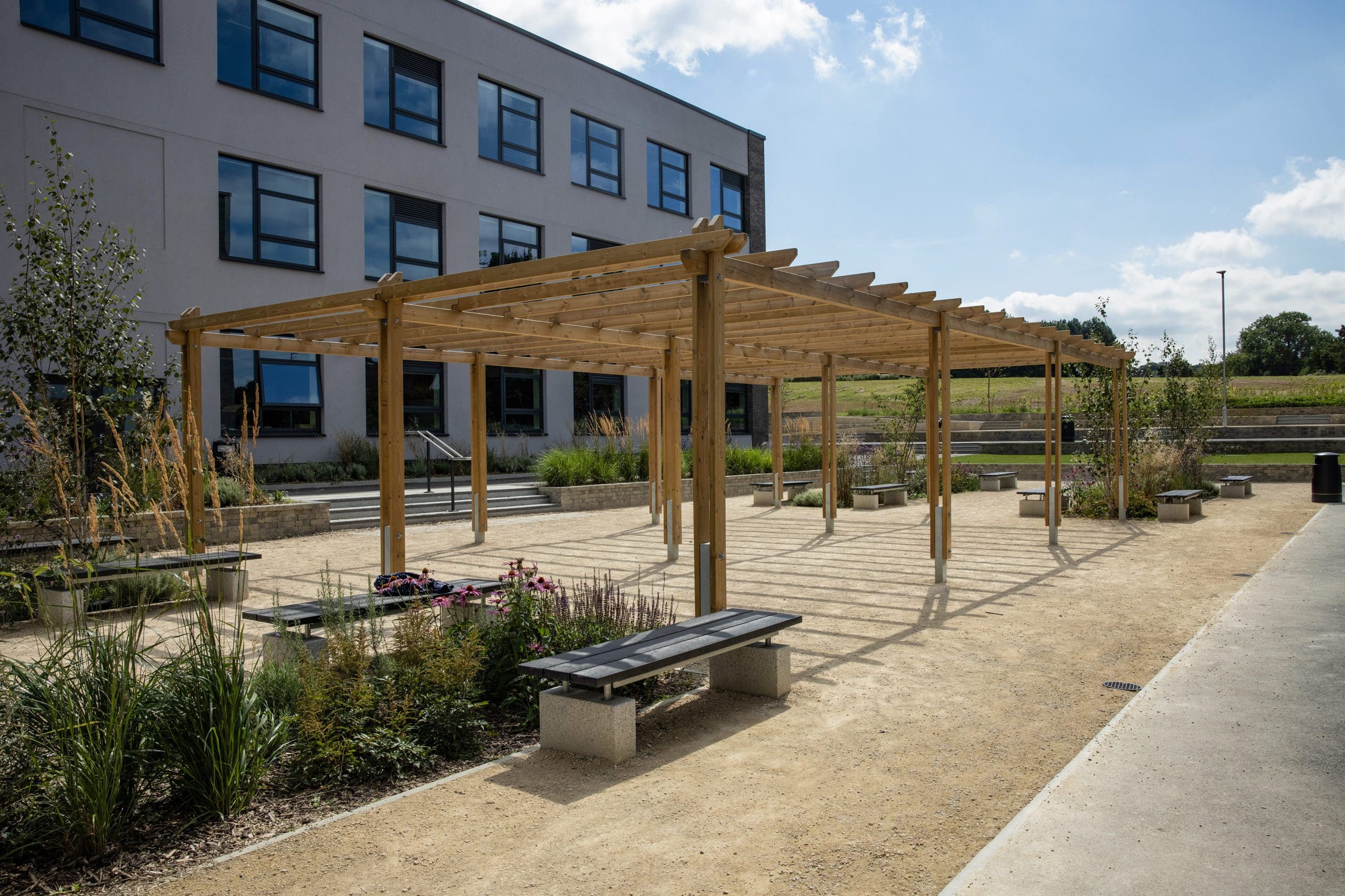 wooden pergola in the middle of the school courtyard