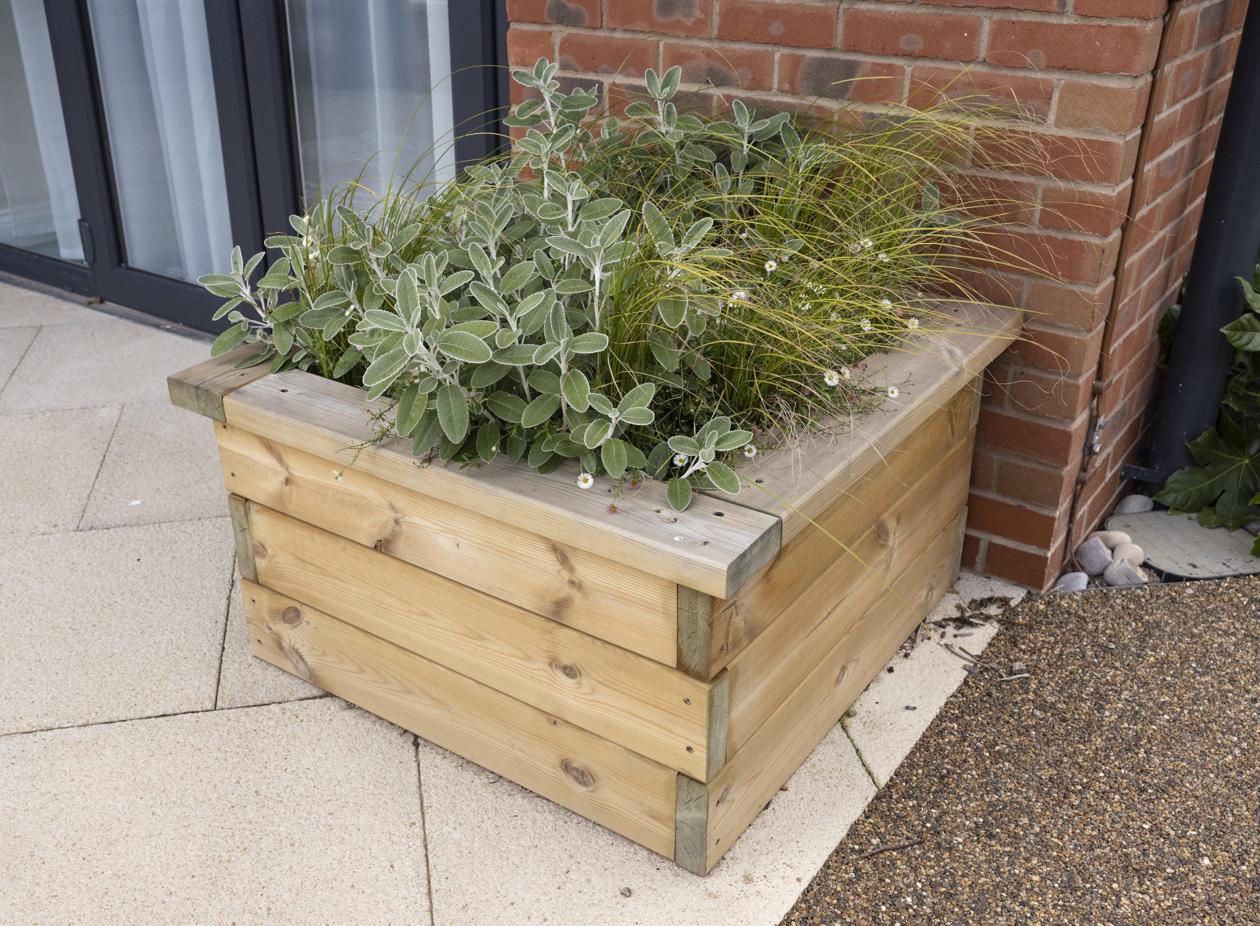 wooden square raised planter on patio