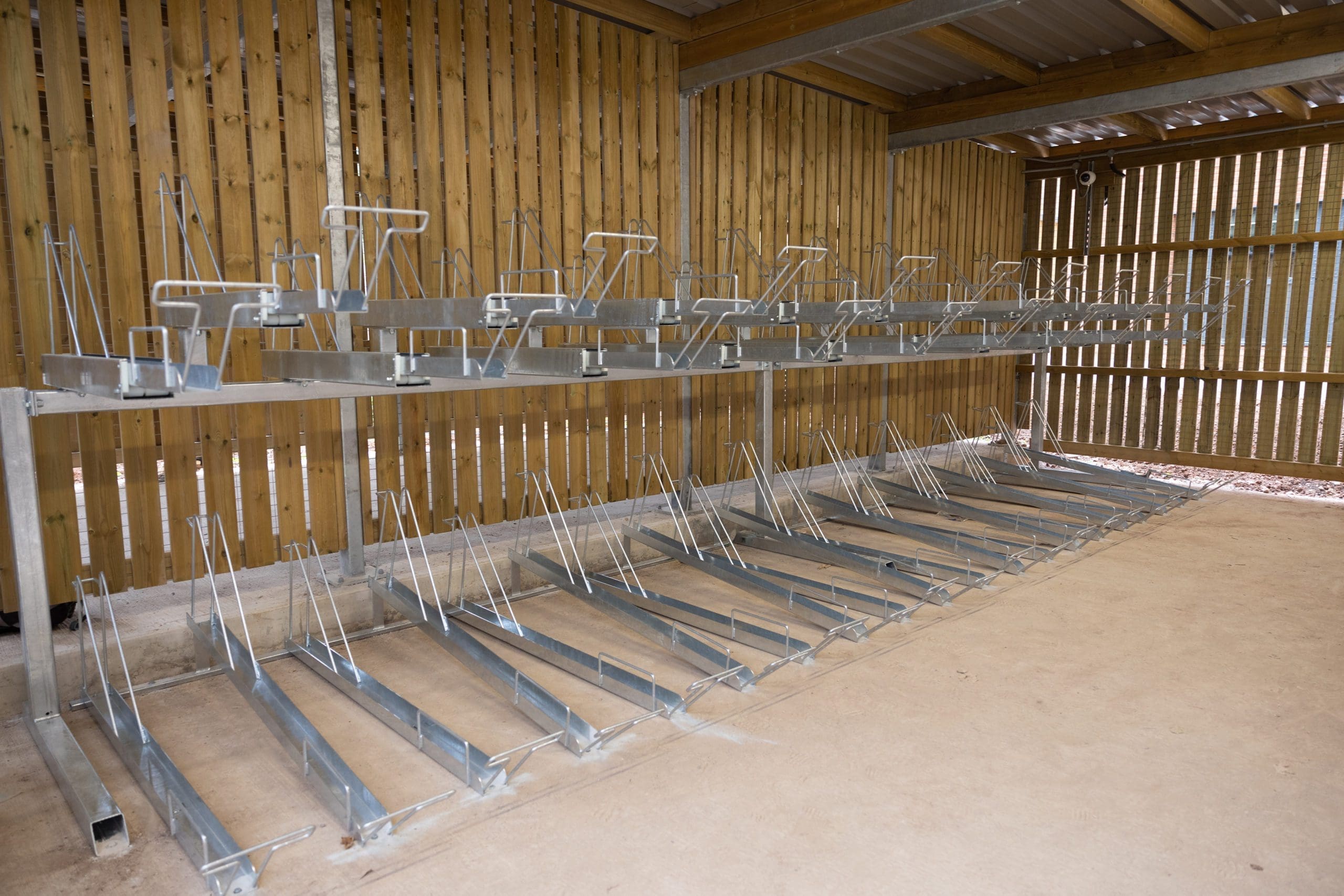 inside wooden bike storage unit with metal bike racks
