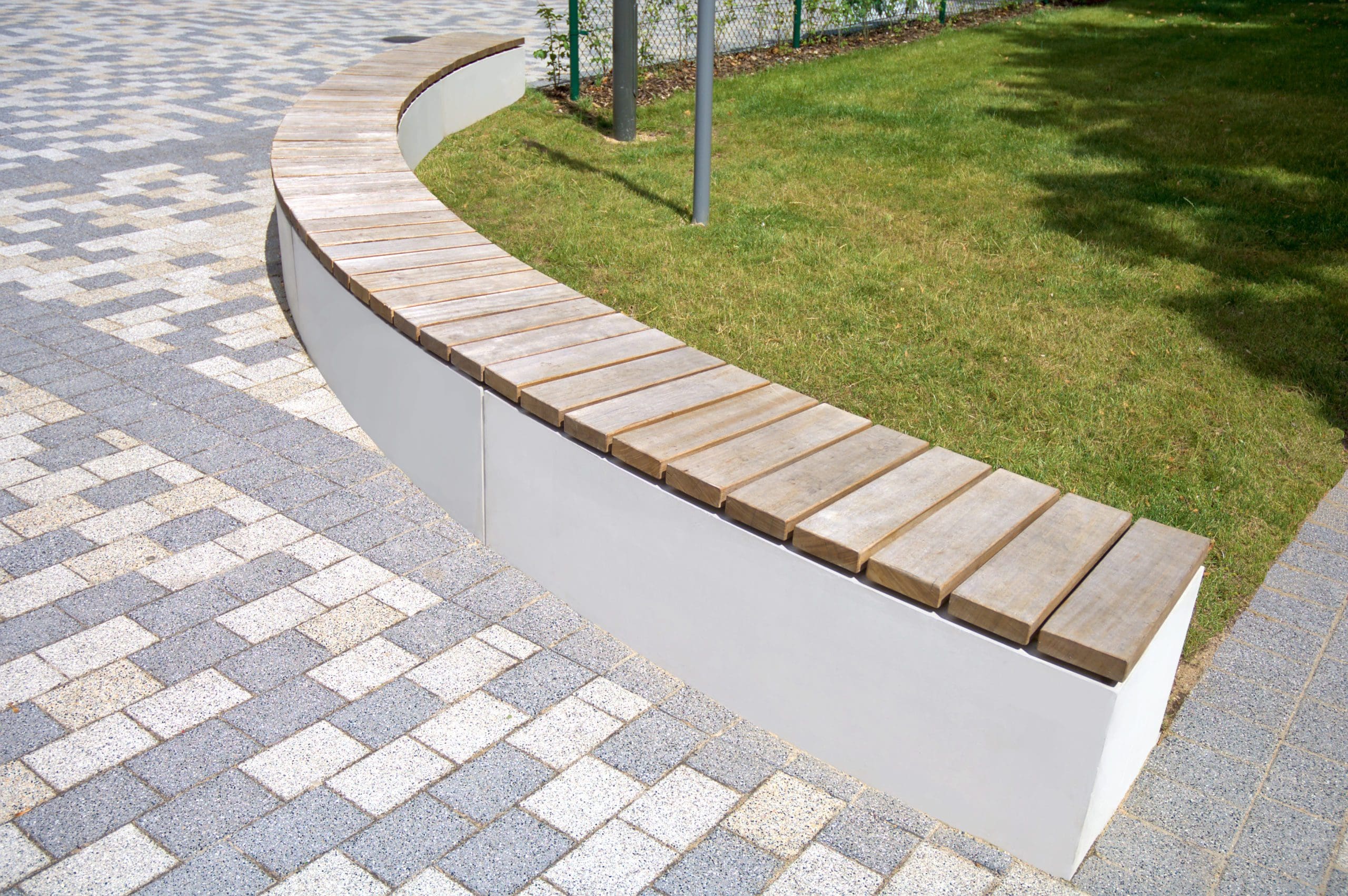 Curved line of concrete rectangle benches with wooden slats on top