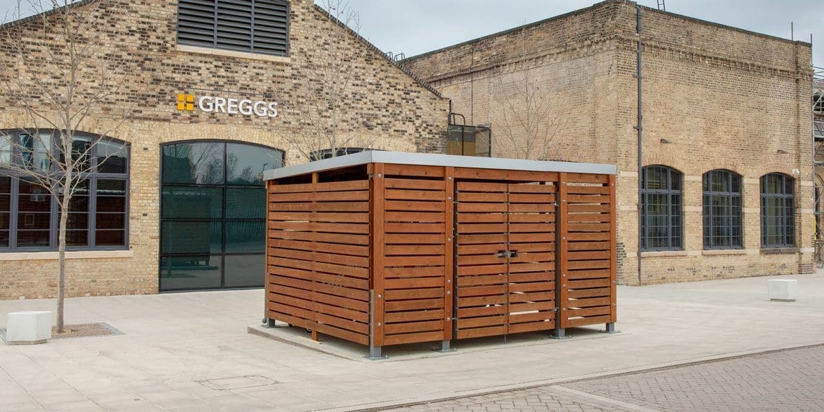 External wooden bin storage infront of greggs store