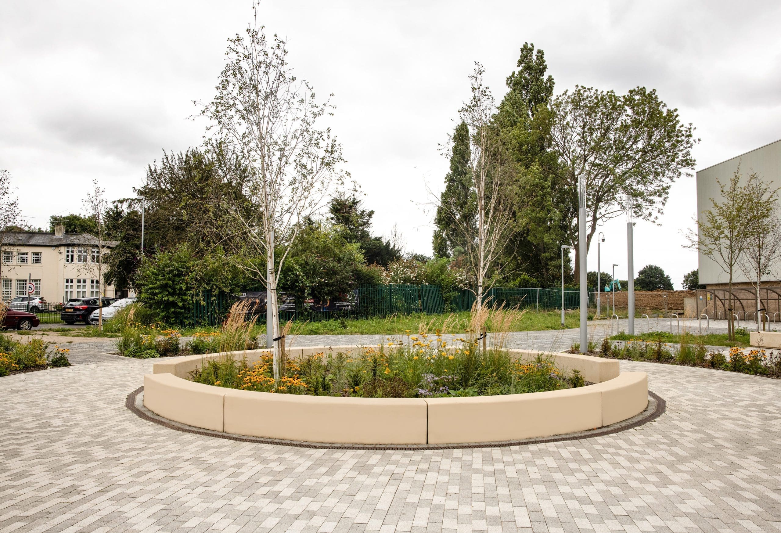 circle of concrete outdoor seating around plants and trees