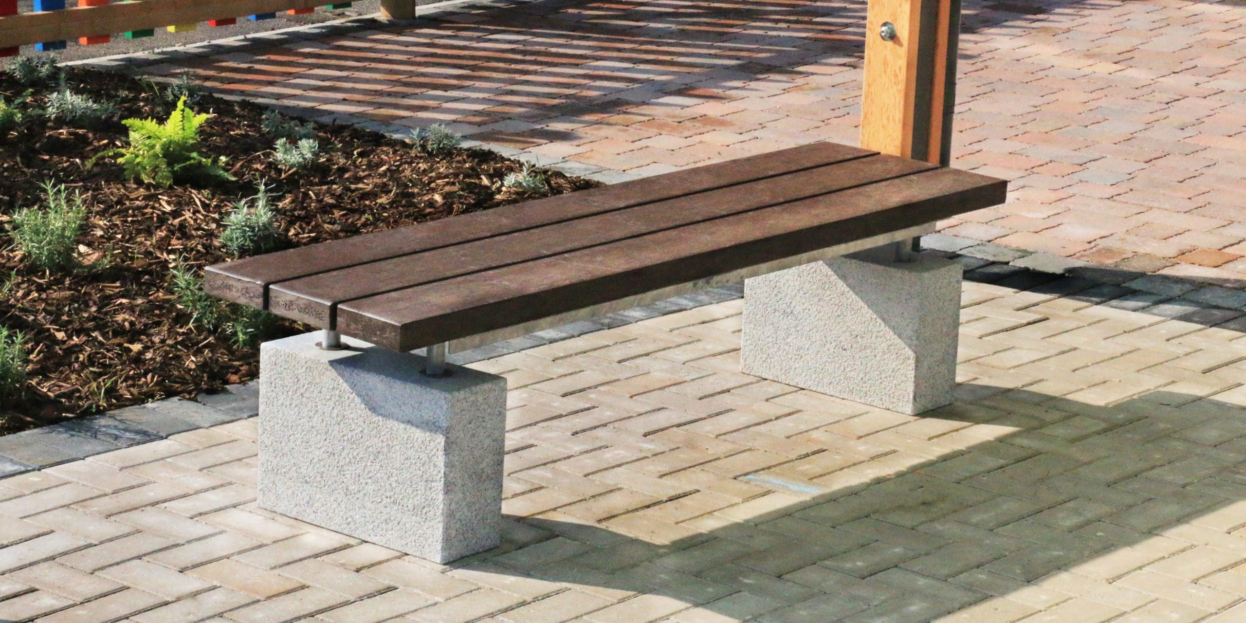 dark brown bench with concrete plinth legs