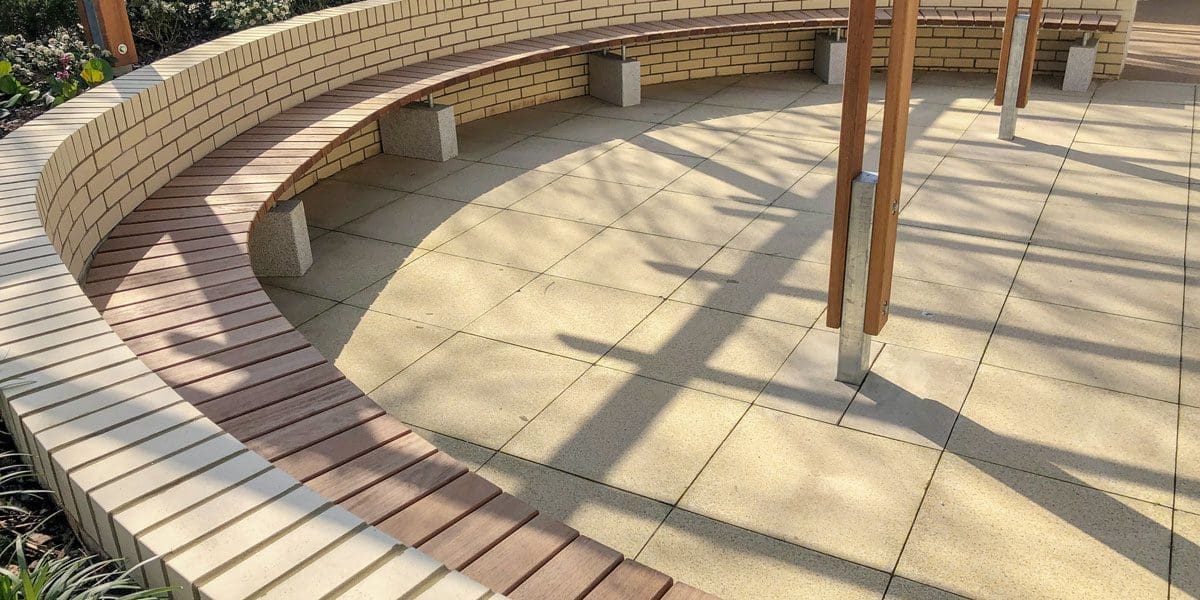 Close up of curved wooden benches against curved wall