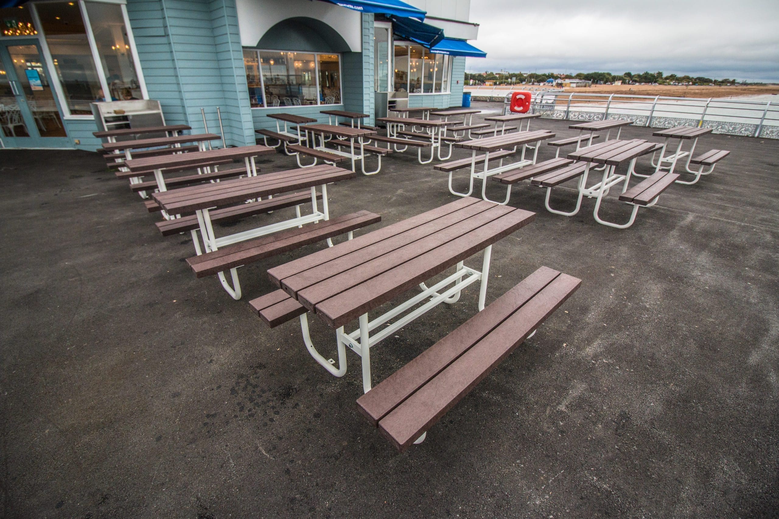 Rows of outdoor wooden picnic table with metal legs