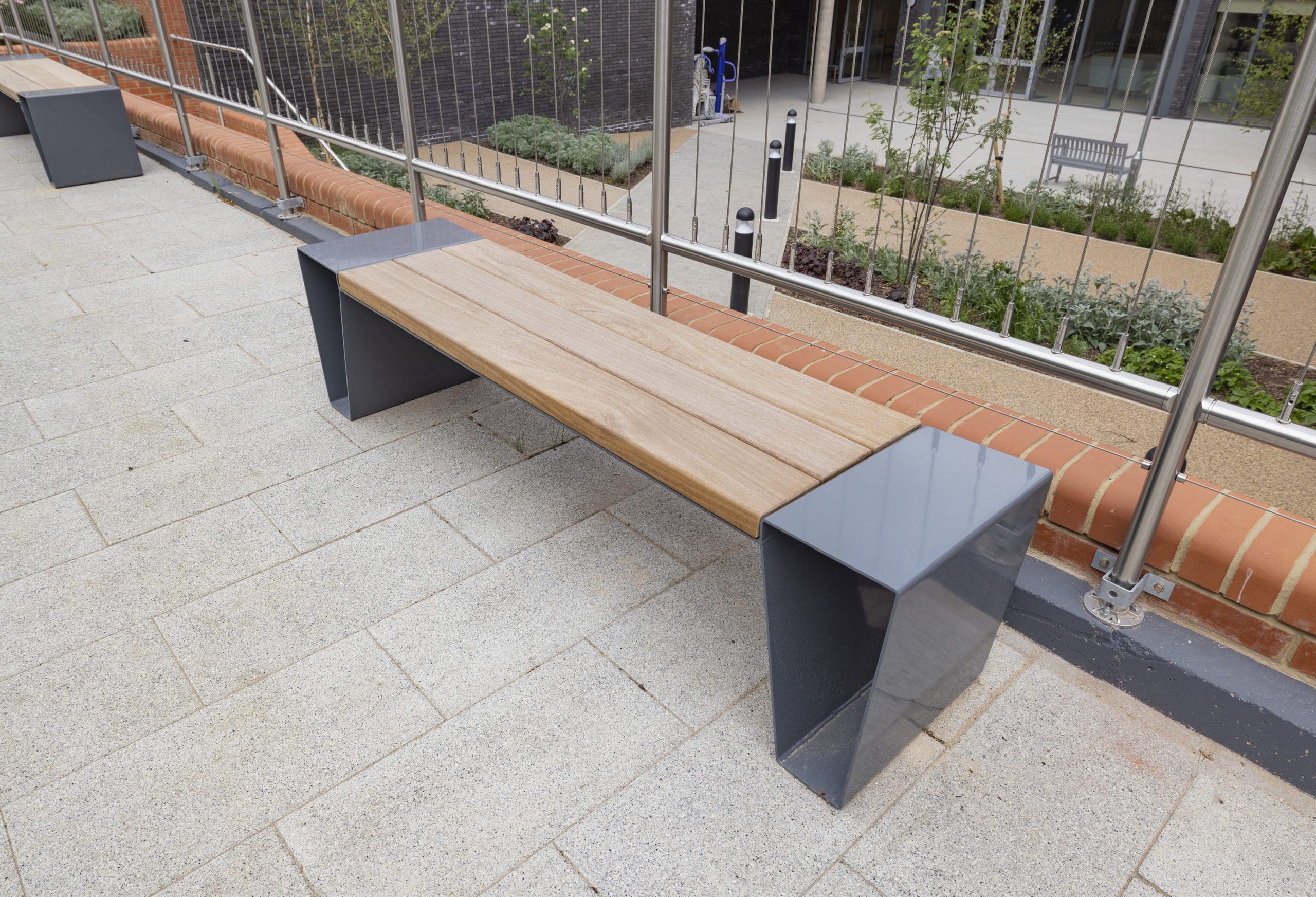 Modern outdoor wooden benches with metal triangular shaped legs