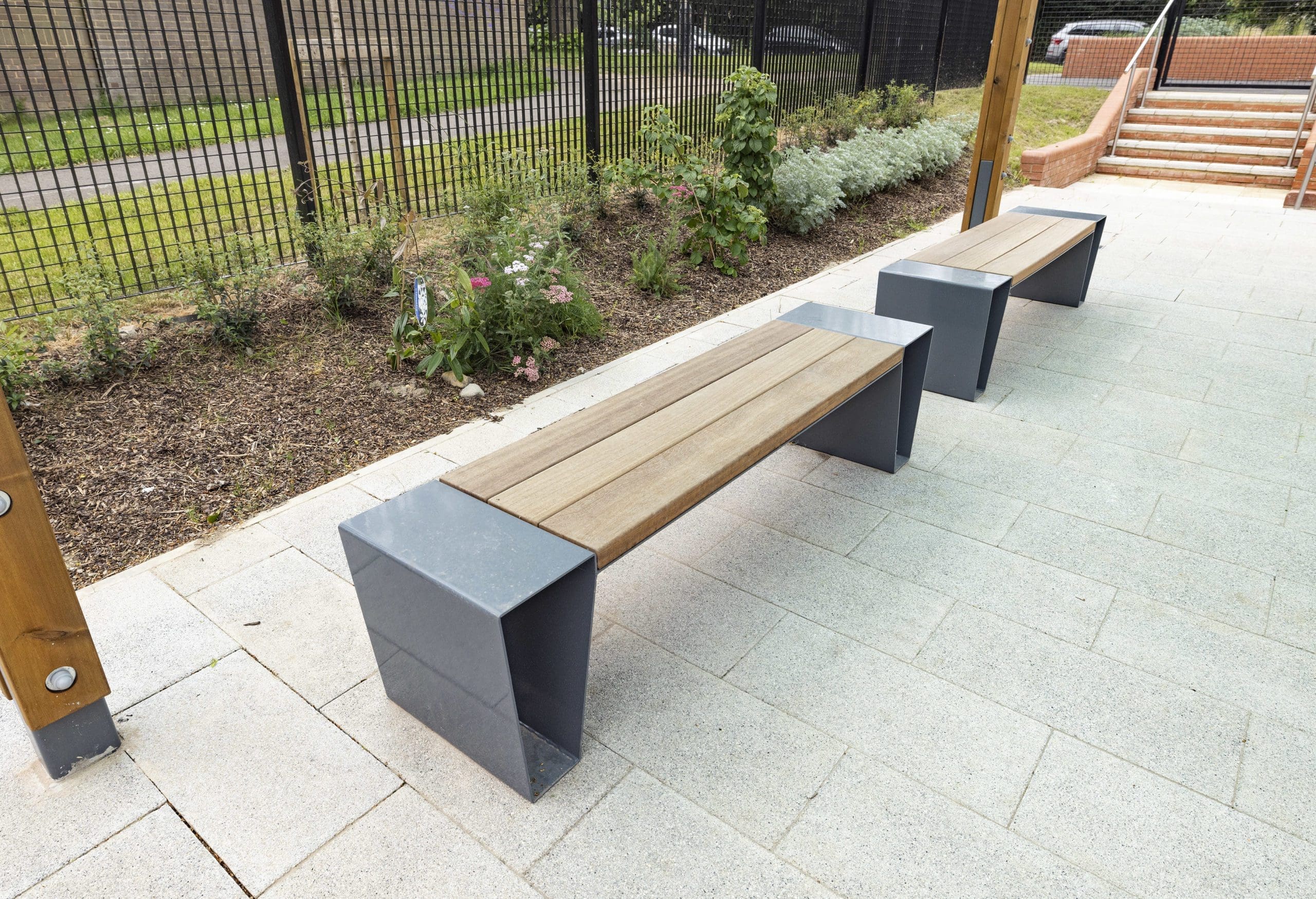 Modern outdoor wooden benches with metal triangular shaped legs