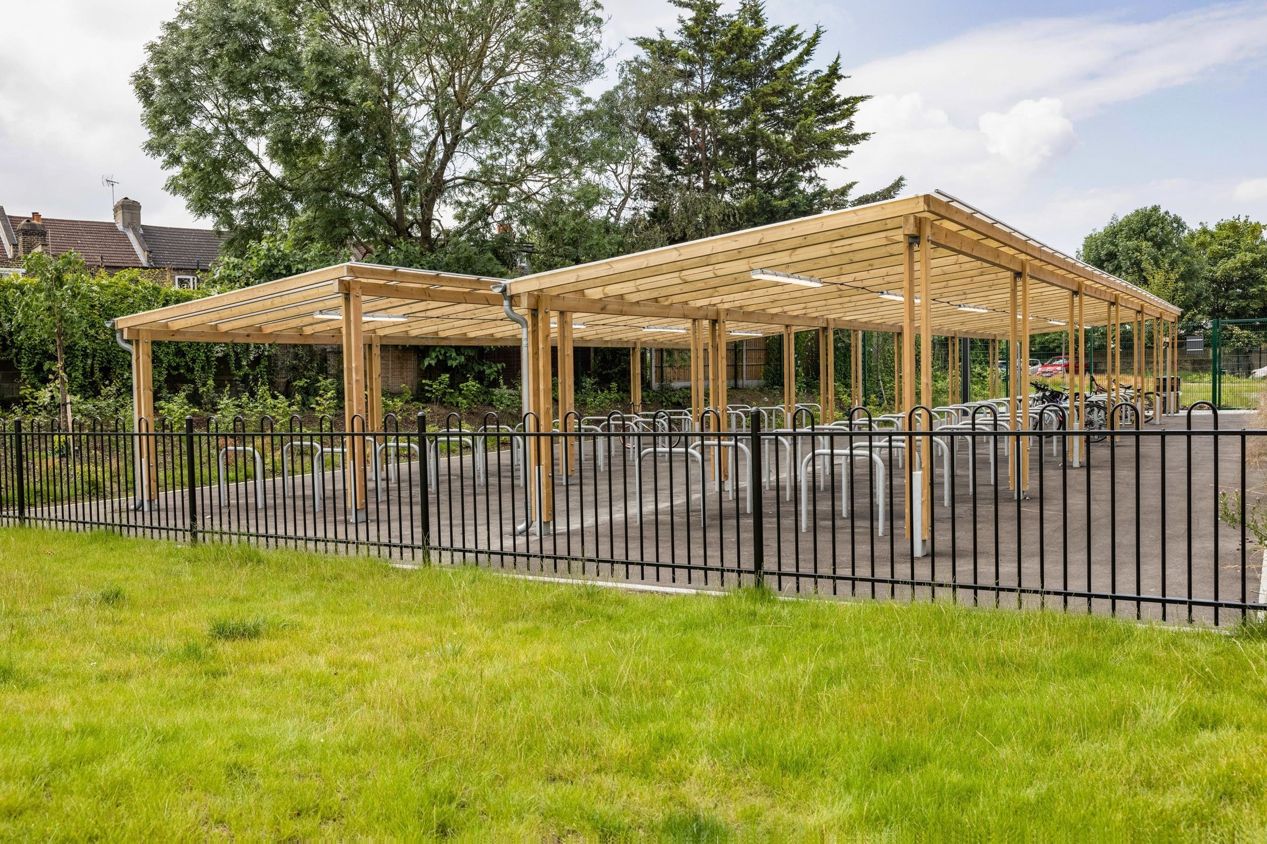 exterior-pergola-bike-storage-metal-curved-rings-in-the-ground