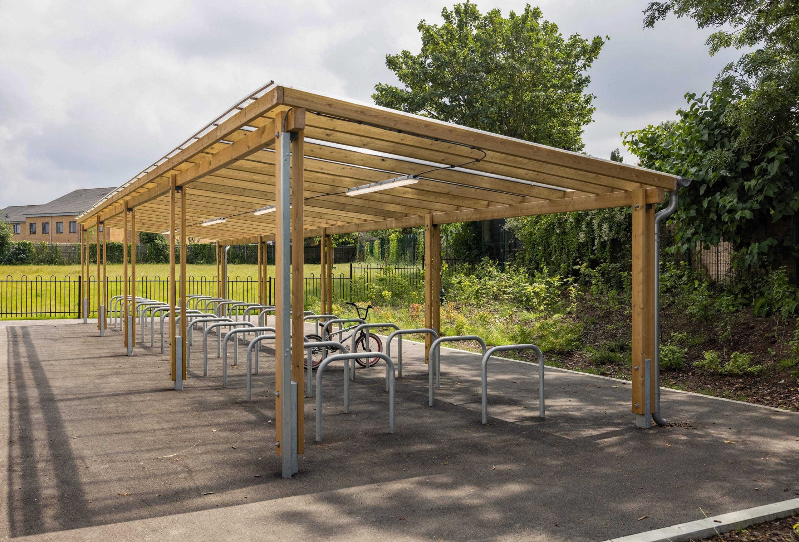 exterior-pergola-bike-storage-metal-curved-rings-in-the-ground