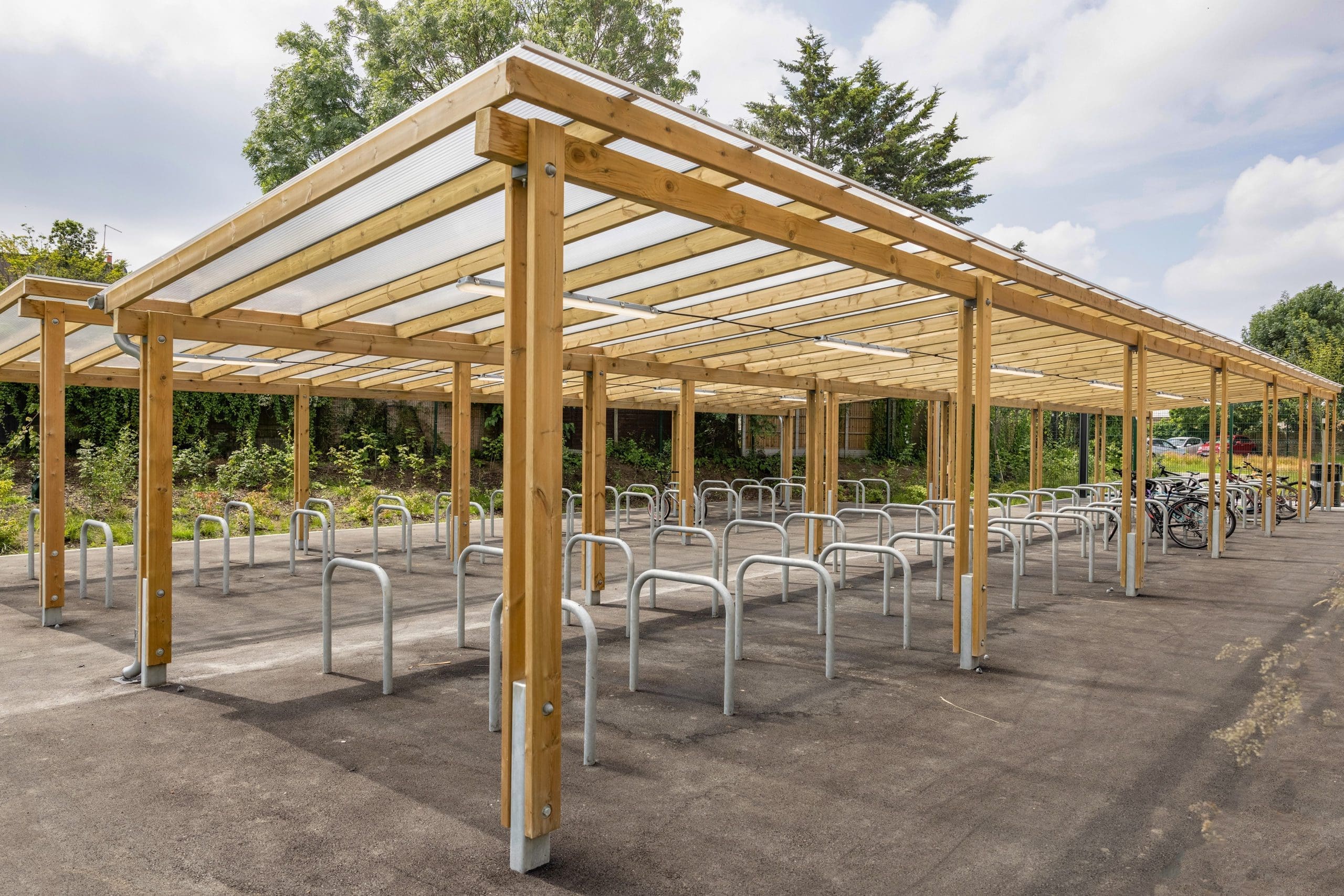 exterior-pergola-bike-storage-metal-curved-rings-in-the-ground