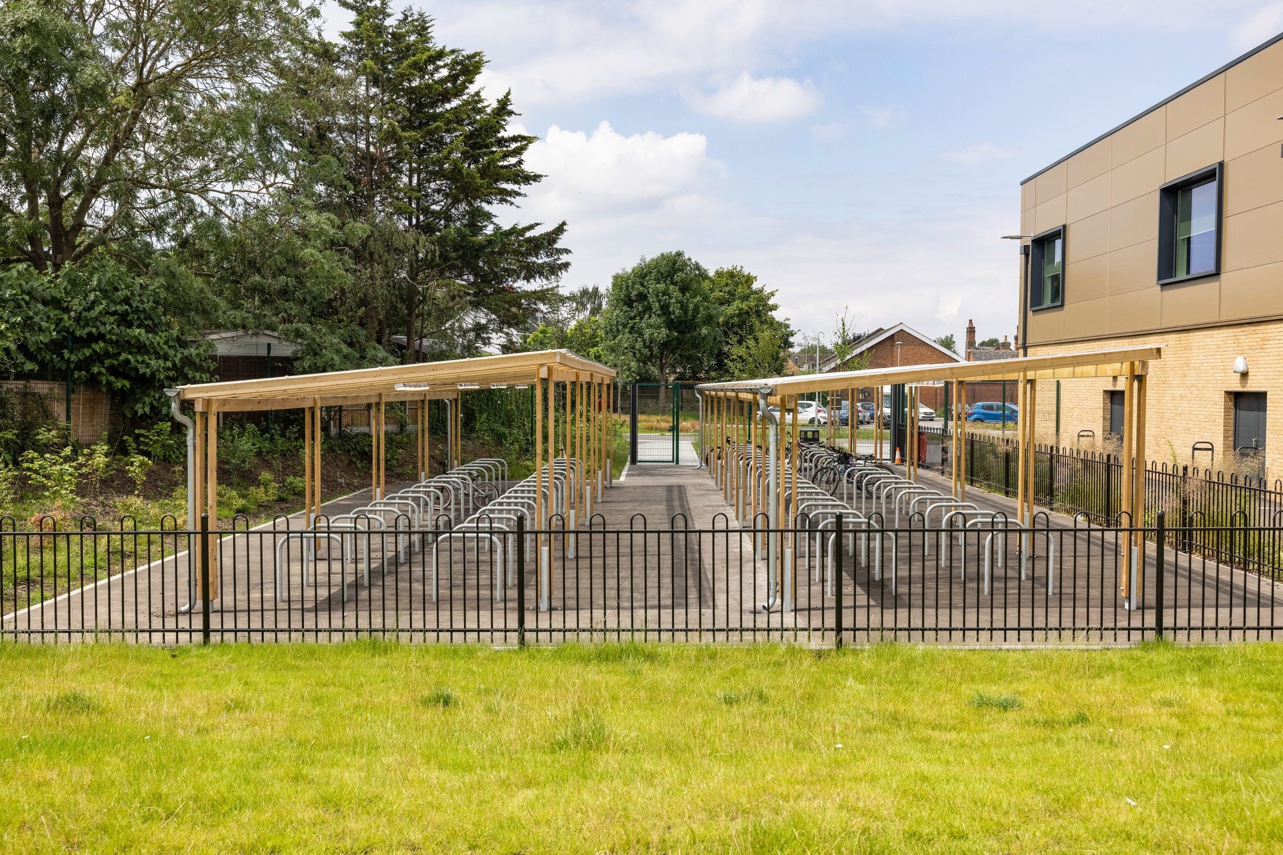 exterior-pergola-bike-storage-metal-curved-rings-in-the-ground